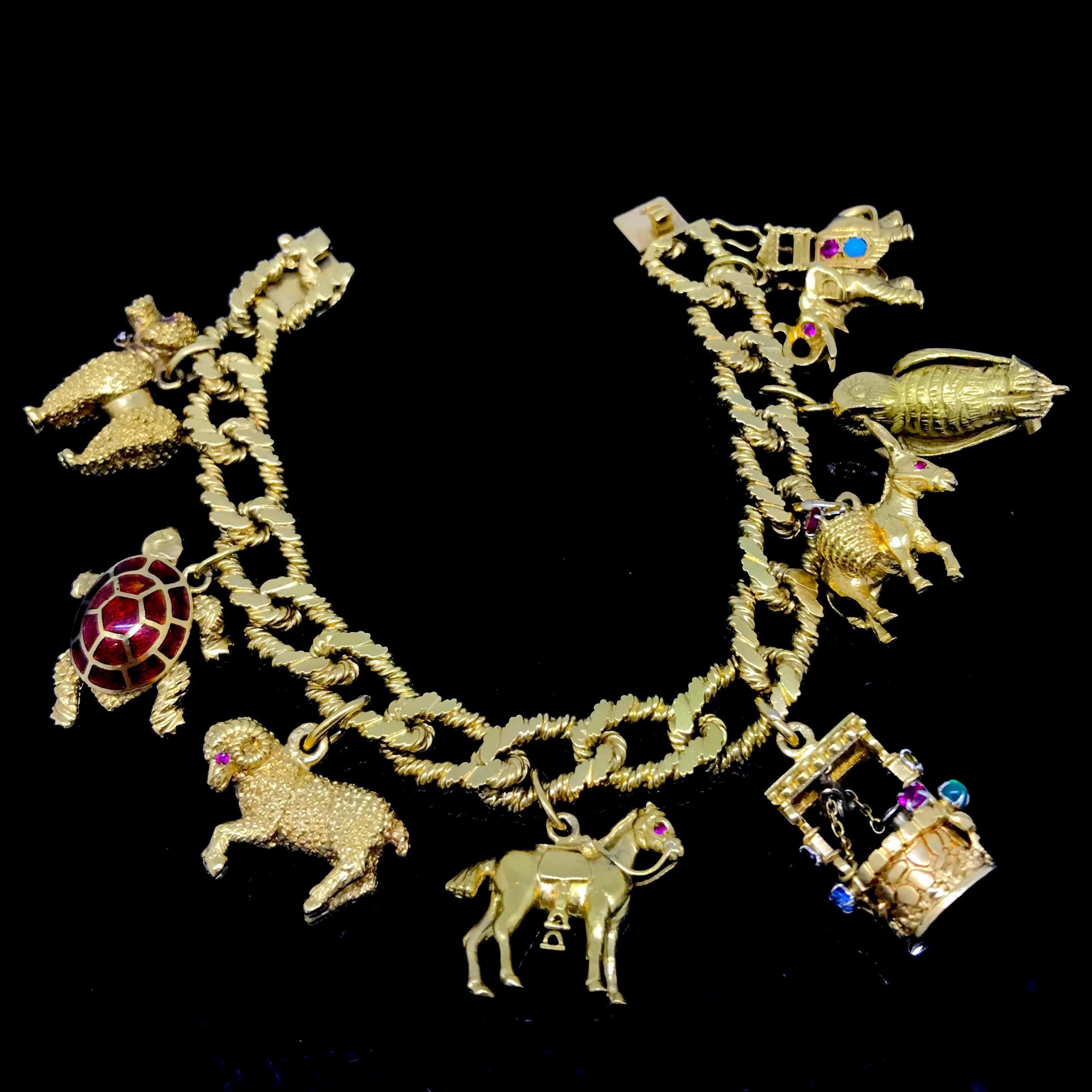 This beautiful vintage charms bracelet is fully made in 18kt yellow gold – each charm and the bracelet are marked with the eagle’s head. There are 8 different charms set with gemstones or enamelled – a poodle, a turtle, a ram, a horse, a well, a