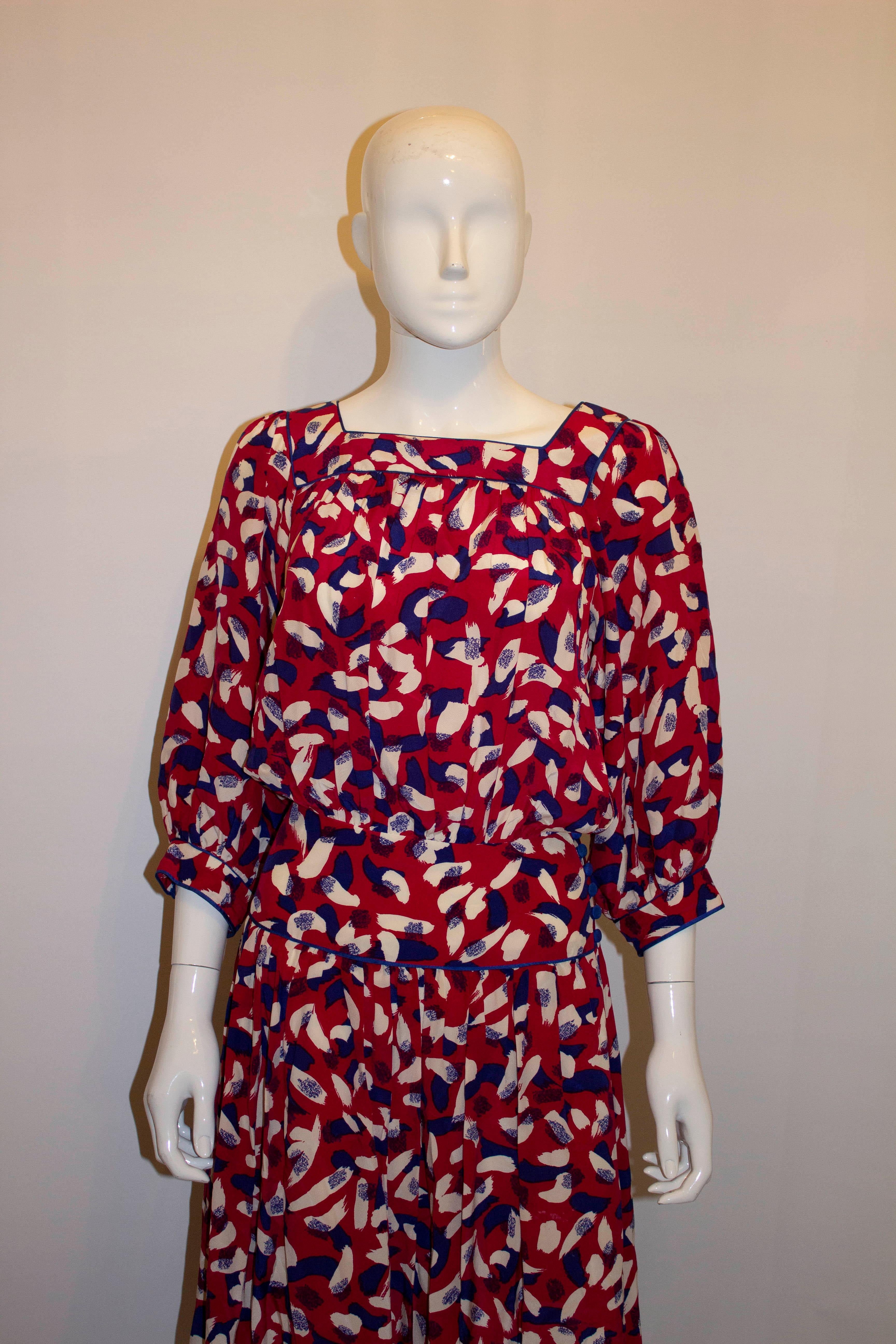 A wonderful and colourful vintage silk dress by Anna Belinda , Oxford.  In a red, white and blue print, the dress has a side opening and poppers. The top is unlined and the skirt lined. 
Measurements; Bust up to 39'', waist 27'', length 51''