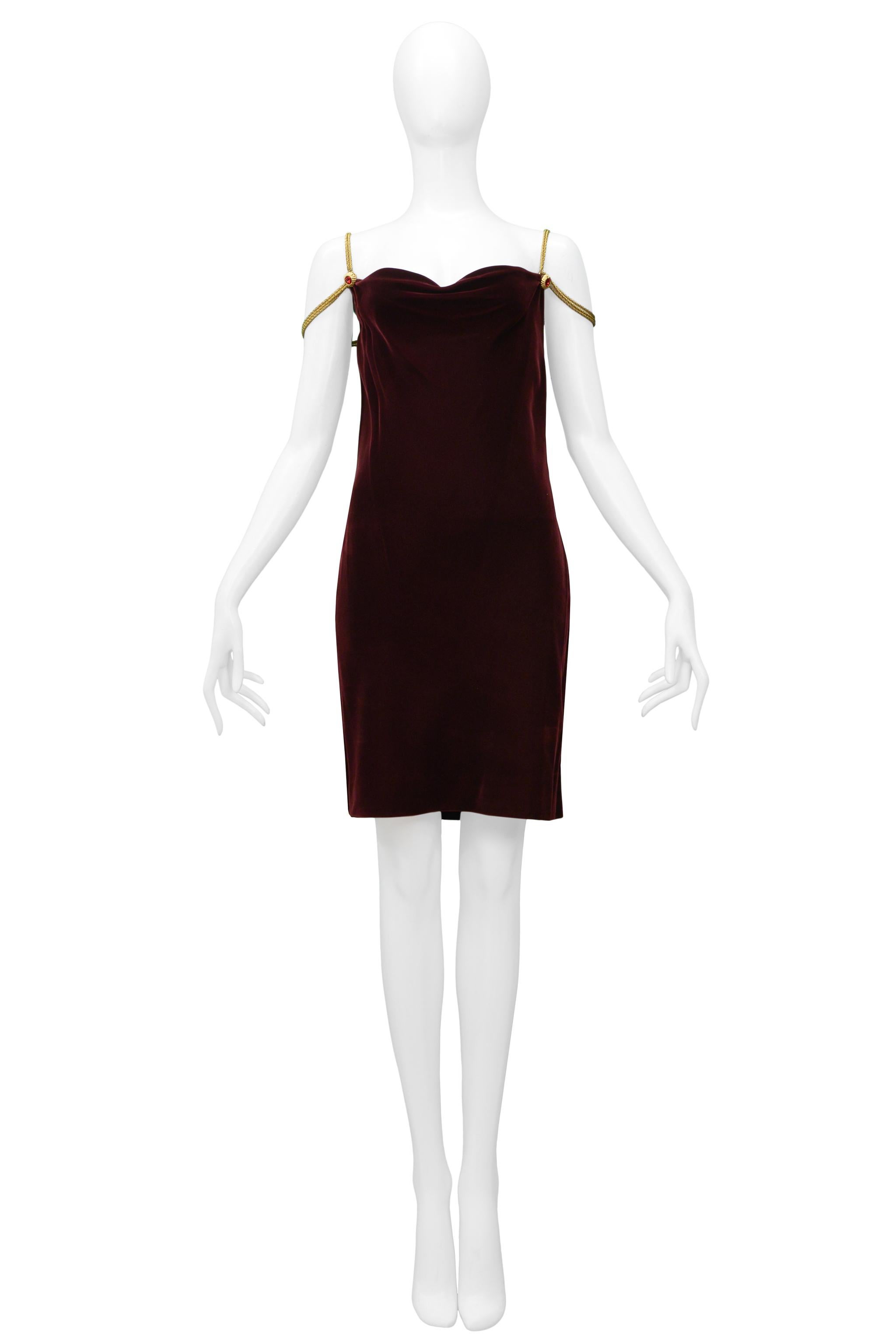 Resurrection Vintage is excited to offer a vintage Anne Klein burgundy velvet cocktail dress featuring an open front and back neckline, gold chain straps, and gold hardware with red gemstones, and mini length.

Anne Klein
Size Small
Velvet and Metal