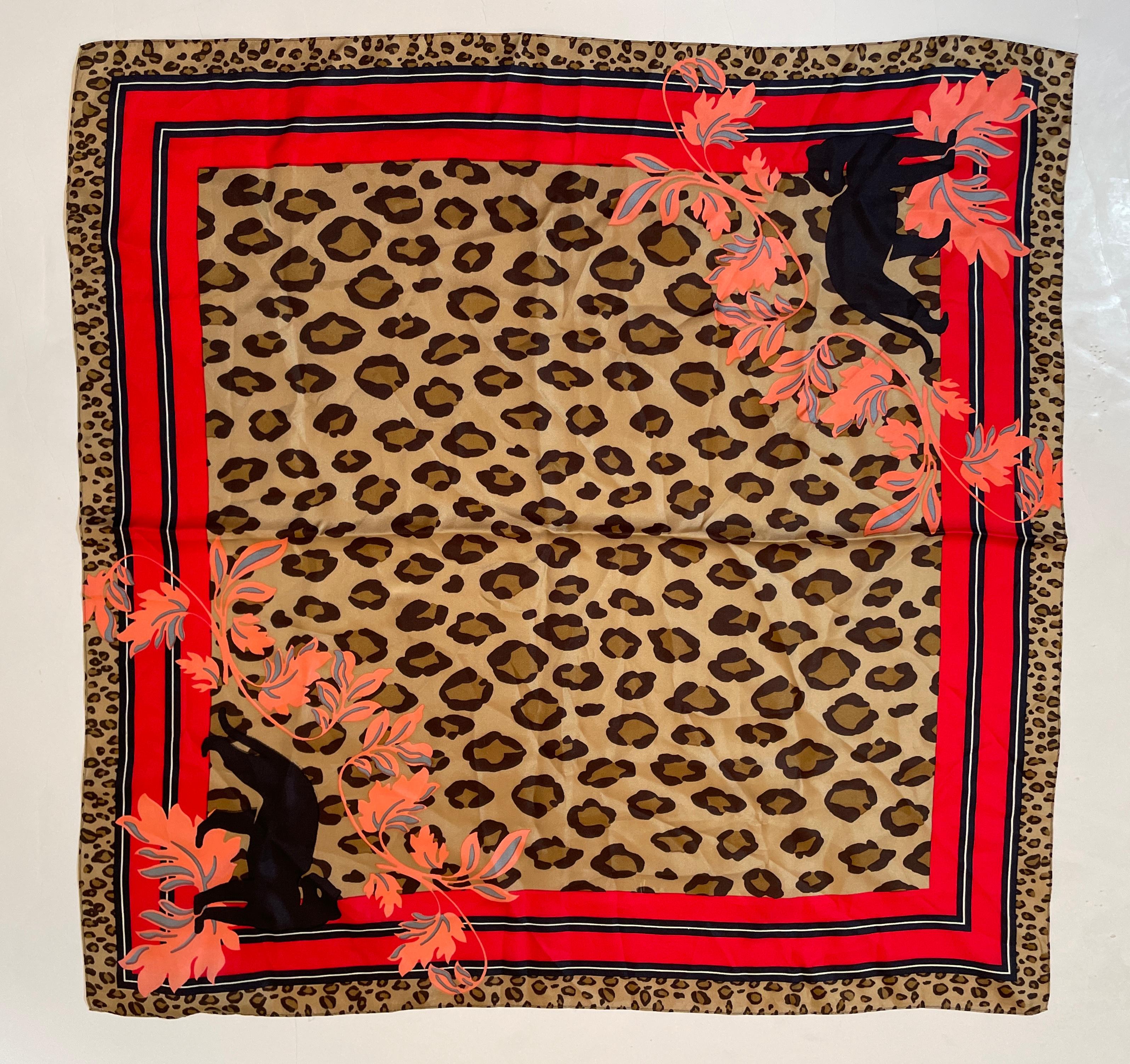 Vintage Anne Klein ‘Leopard Print Silk Scarf.
Leopard Animal Print Silk Scarf by Anne Klein.
Was designed by Anne Klein. 
The center design highlights the leopard’s fur with pale yellowish to dark golden with dark spots. 
Framing the center is a