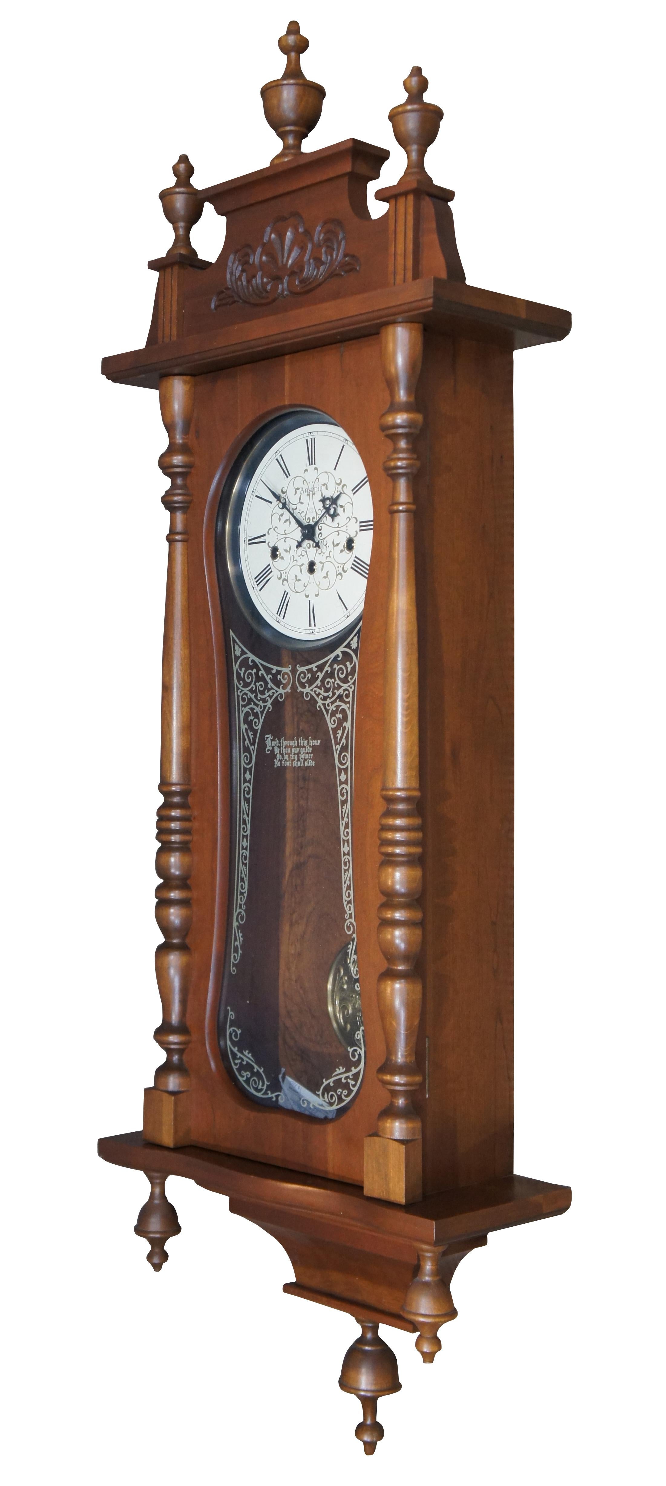 Vintage Ezee-Set #725 wall clock by Ansonia Clock Company. Case features spindle columns and urn shaped finials, carved scallop/floral detail on the pediment, molded grapes on the brass pendulum, and a painted glass front with the words “Lord,