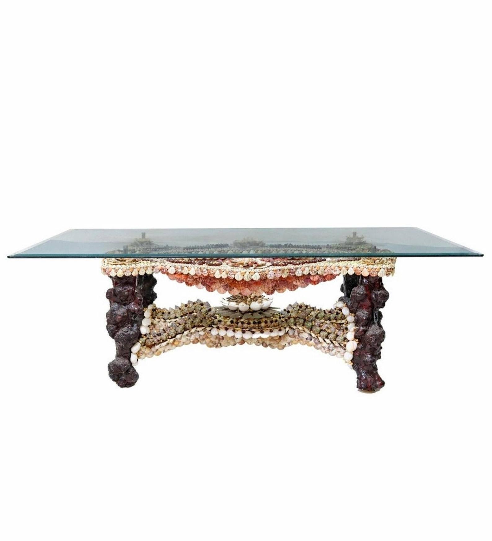 A spectacular shellwork decorated table, artistic one-of-a-kind example, exceptionally executed design in the manner of Anthony Redmile (British, b.1940), dating to the late 20th century, having a rectangular beveled glass top, over stunning