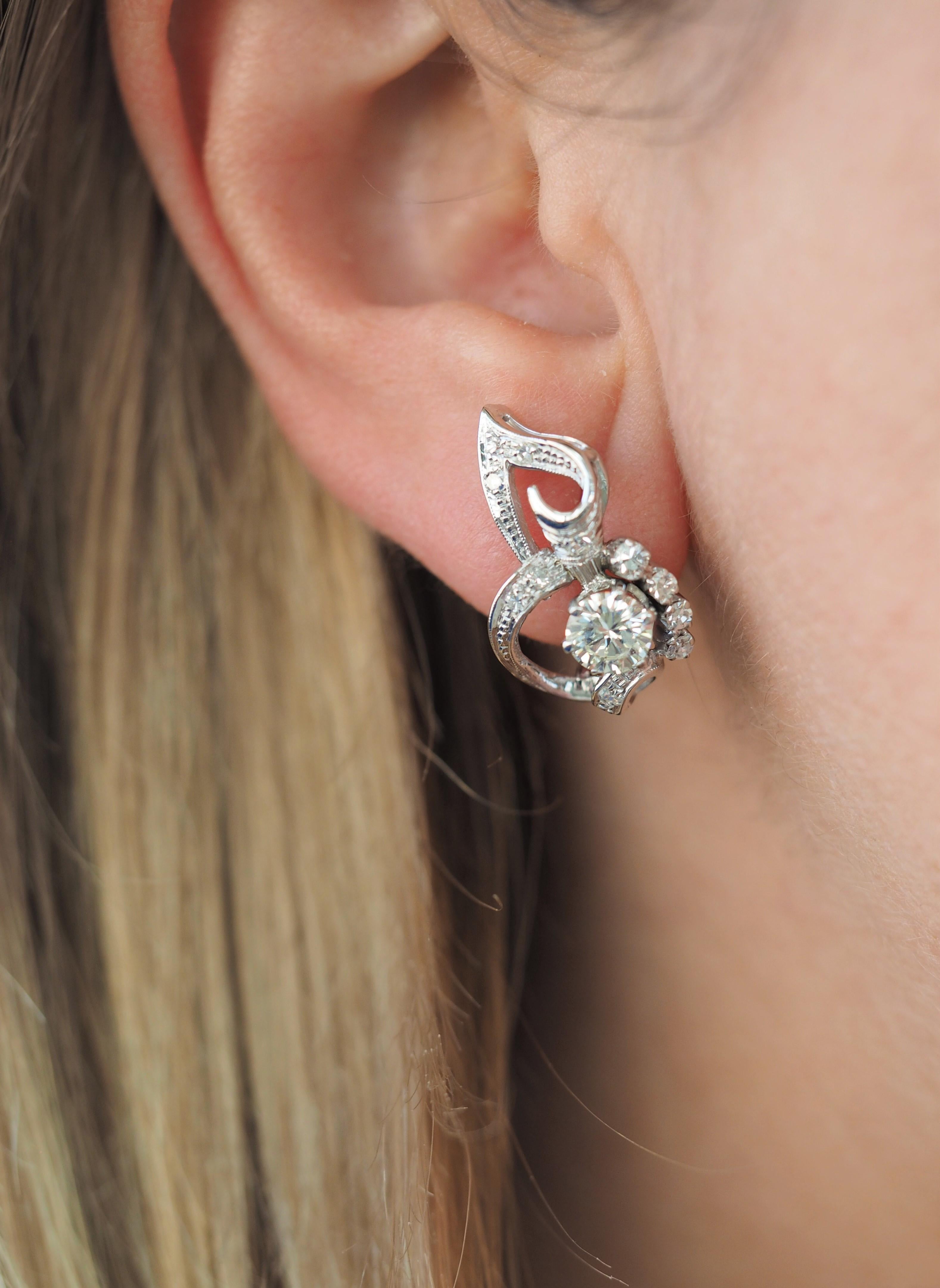 Vintage Antique 18 Karat White Gold Round Diamond Flower Earrings. 
Earrings weigh 5.6 grams. Dimensions 12.6 x 20.6 x 5.4 mm.

Earring Details:
Metal: 18K White Gold
Weight 5.6 grams 
Dimensions: 12.6 x 20.6 x 5.4 mm
Stamped:  None 

Diamond