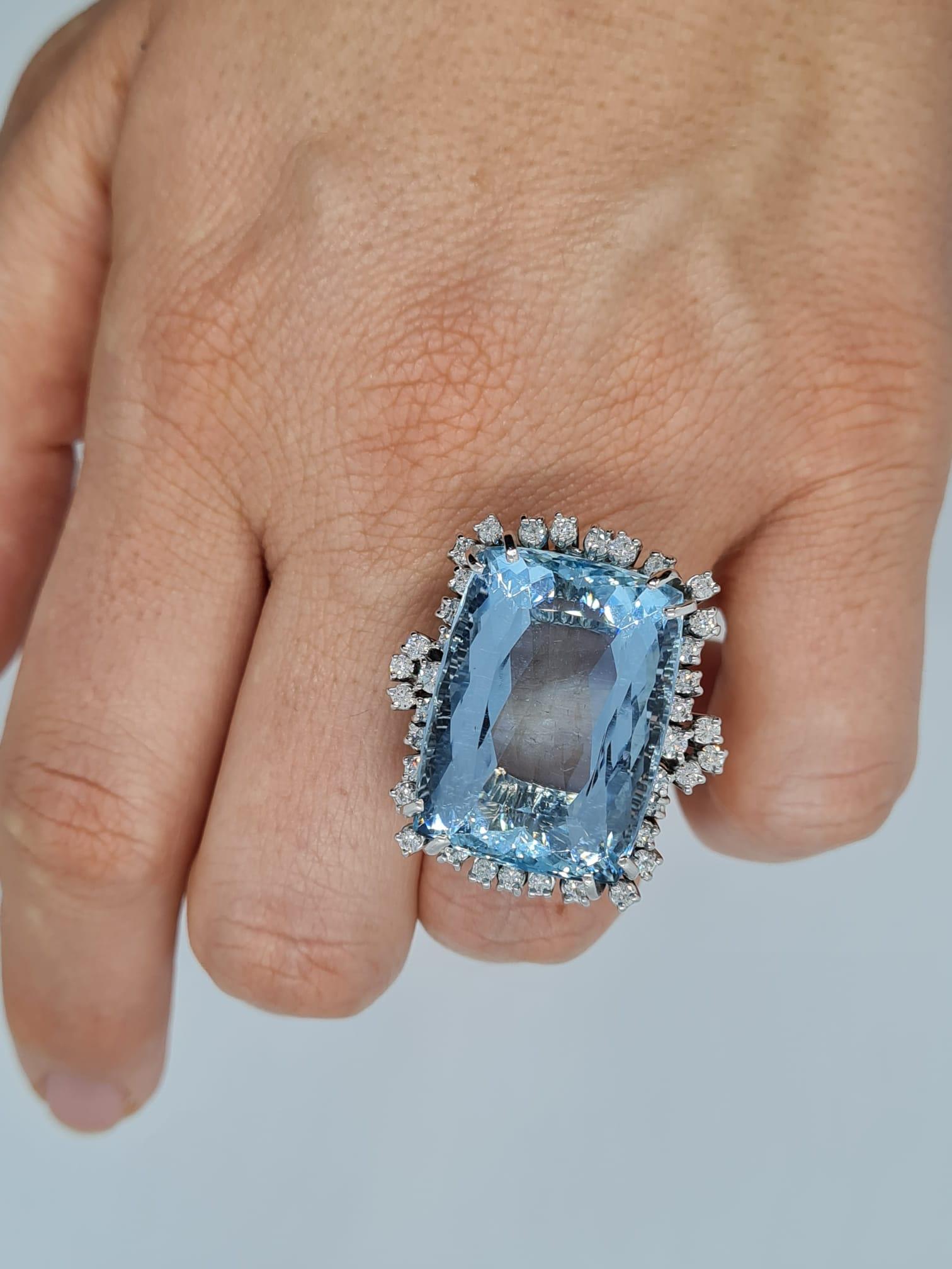 This exquisite handmade in Italy vintage 40 carat authentic aquamarine and diamond ring has been made more than 50 years ago. 
The main stone is an authentic aquamarine and comes from a to a very important heirloom.