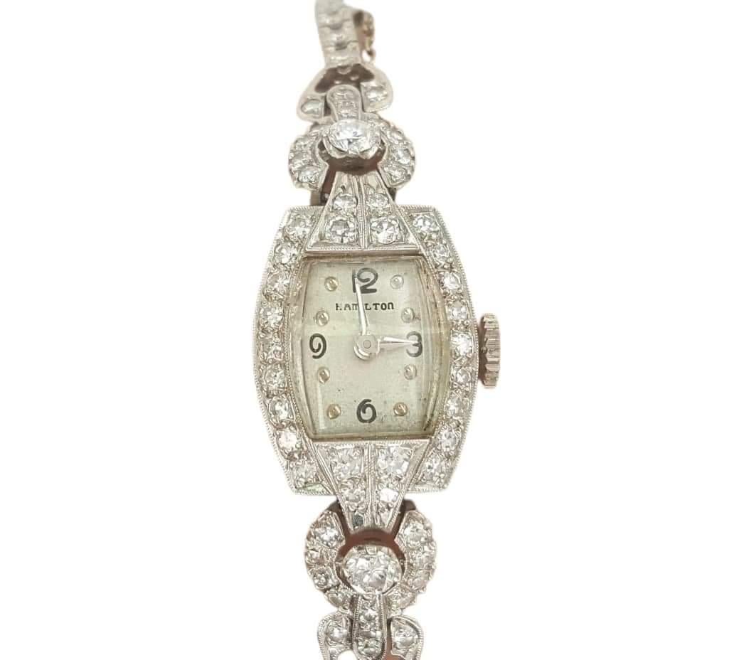 A Vintage Hamilton wind-up ladies  watch set with beautiful round cut diamonds in a luxury style. It is Cast in Platinum flowing with approximately 1.80 carats of round European cut diamonds. Stamped 