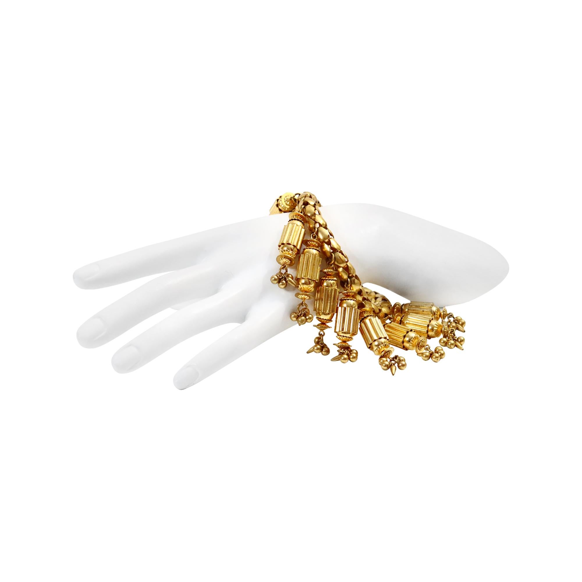 Vintage Antique Gold Dangling Columns Circa 1940s. This is a very unusual-shaped bracelet.  The color is a darker antique gold.  The bracelet section is a braided chain.  The dangles are substantial. They are like small columns that have been