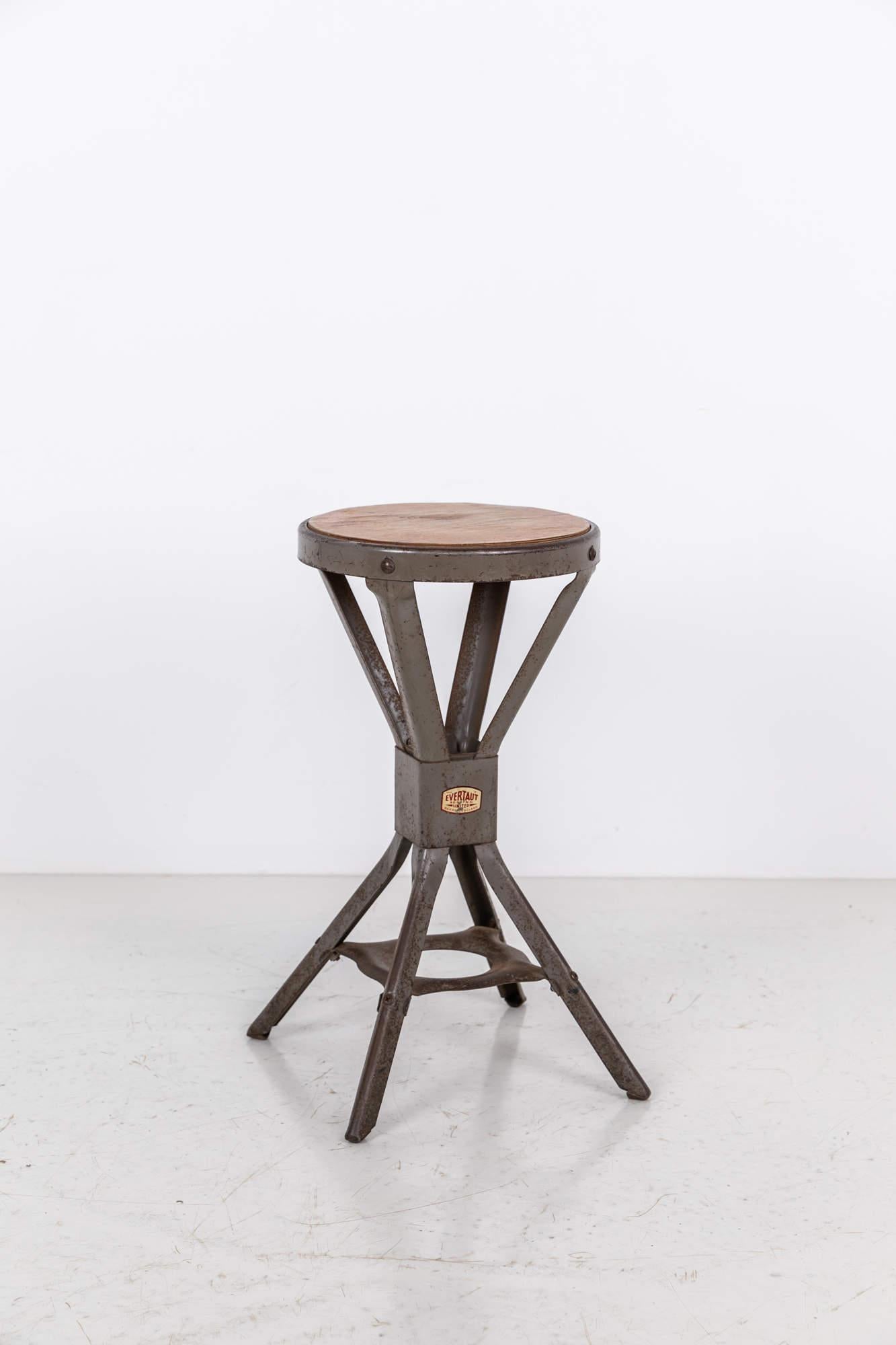 Simple yet elegantly formed industrial stool made in England by Evertaut. c.1940

Iconic shaped steel frame and original grey paint and circular ply top. Evertaut maker's label to stem. 