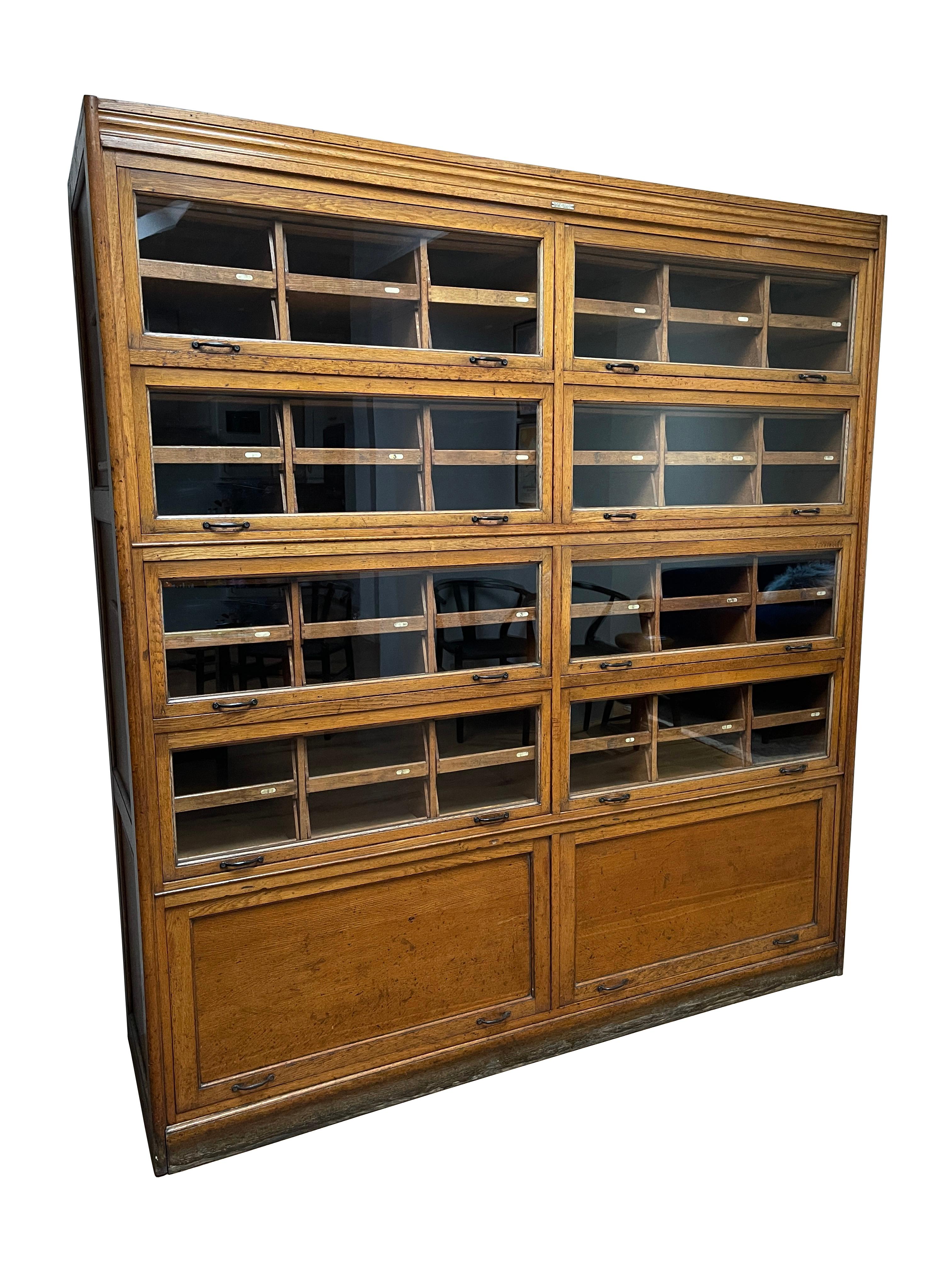 - A large and wonderful oak haberdashery glass display cabinet, English circa 1940. 
- The cabinet is marked by the illustrious 'Dudley & Co Ltd. Showcase Manufacturers Holloway. London. N.7.'
- A total of 48 dovetail jointed open drawers embossed