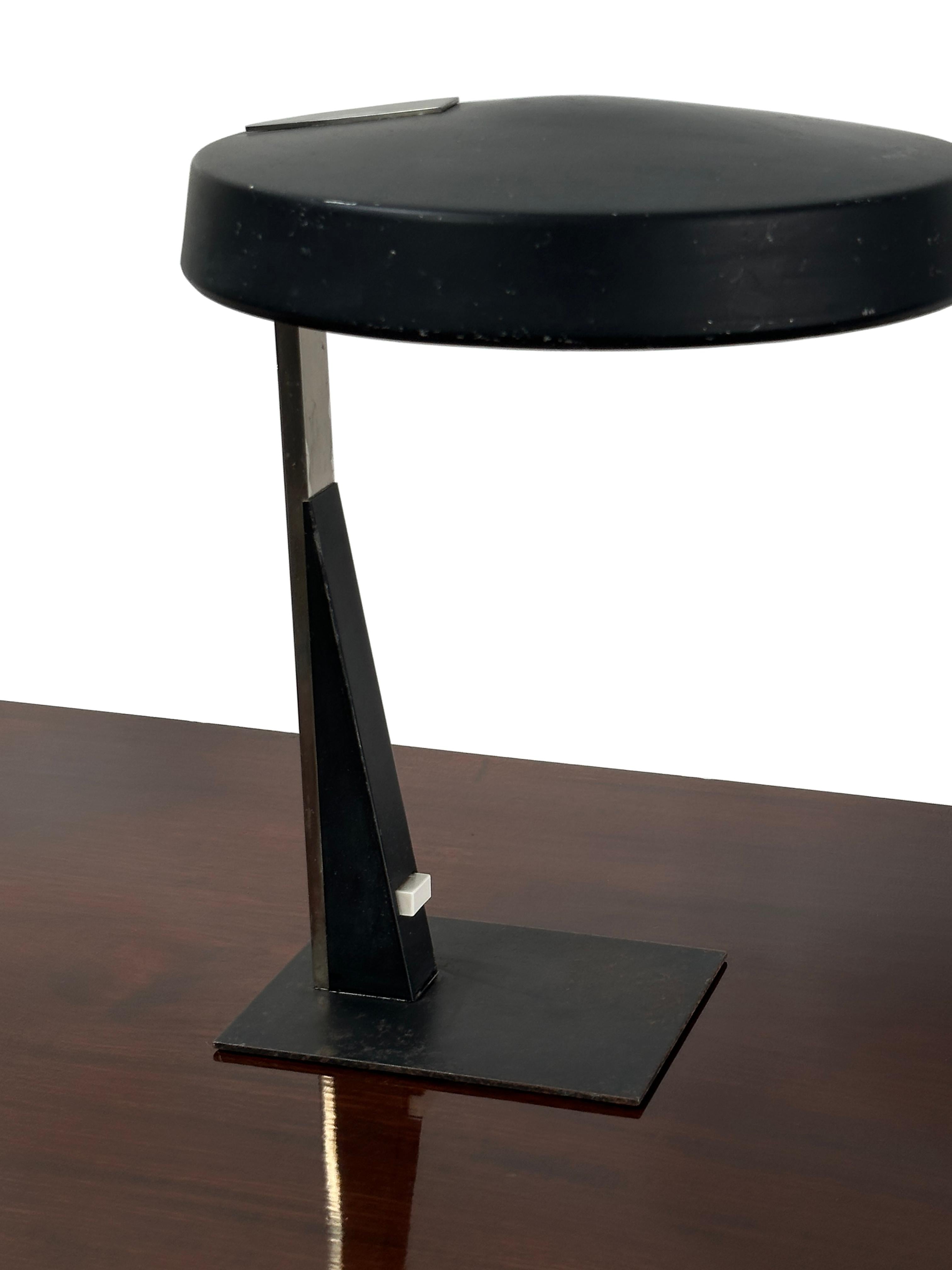 - A stylish black adjustable desk lamp by designer Louis Kalff for Philips, The Netherlands circa 1950.
- Original switch plate and adjustable light position via the shade, rewired in black braided flex and PAT tested.
- The lamp stands out with a