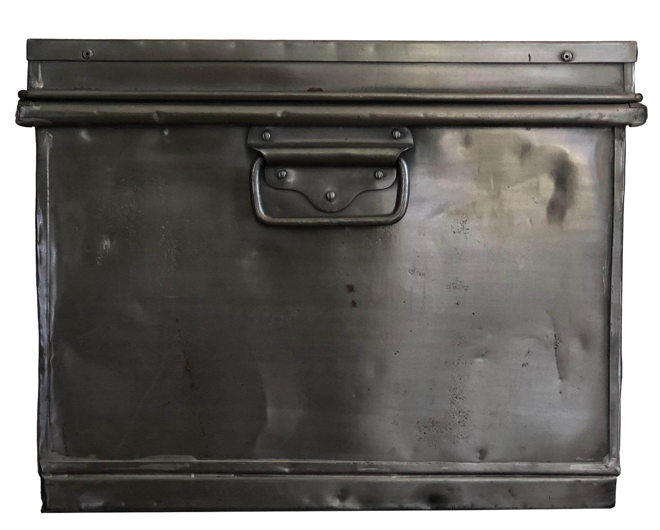 Vintage antique metal trunk chest with beautiful brass hardware and a brass plaque on the too center. Bluish painting on the interior. I can imagine that this trunk had a special purpose with its original owner and has seen a lot of the world.