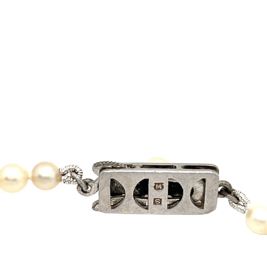 Presenting an exquisite mid-20th century Mikimoto Pearl necklace, circa 1950, in its original box. The necklace features a single strand of Japanese Akoya cultured pearls, numbering 98 and ranging from 3.5 mm to a central 8 mm pearl.
 
Fastened with