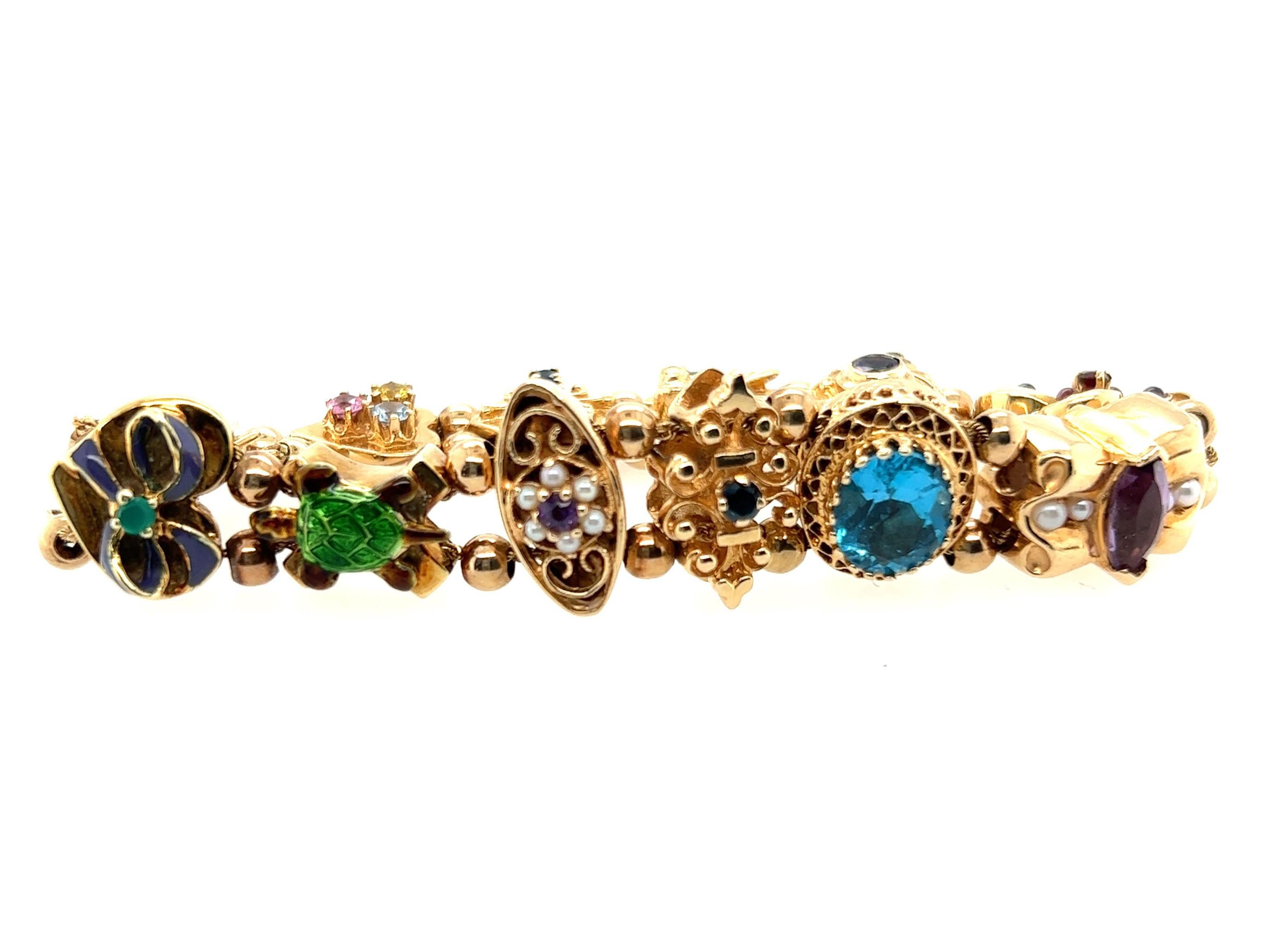 Genuine Original Antique from 1949 Vintage Slide Style Charm Bracelet 14K Yellow Gold Retro



Features Multi Colored Gemstones

This Bracelet Weighs a HEAVY 35.5 Grams

That's Over $1,250  in Gold Value Alone

Intricate Hand Carved Charms

Bow,