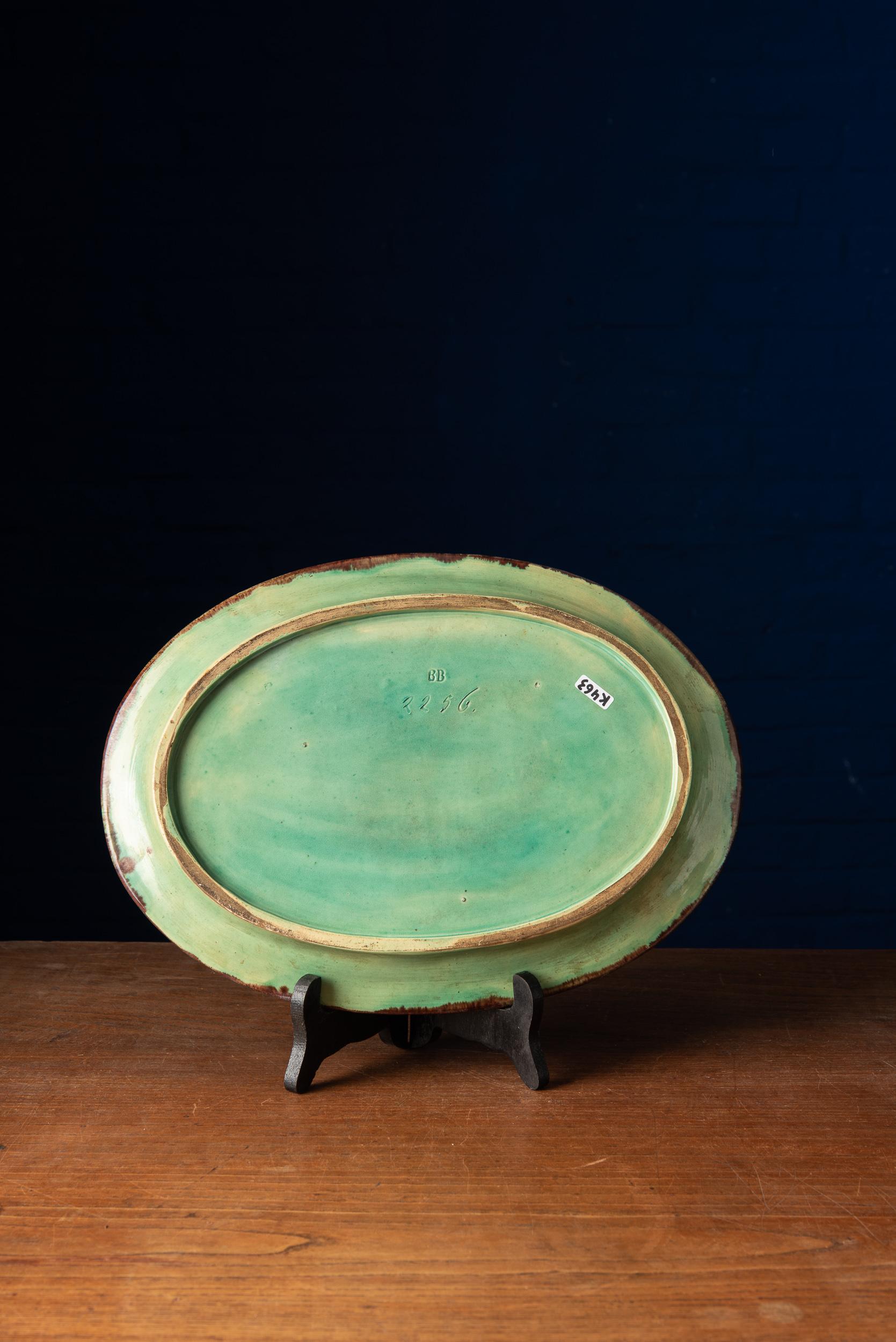Lovely ceramic plate with hand painted shades of blue and green. This item displays elegant and charming features. A remarkable piece of art with a hand stamped tag on the bottom.