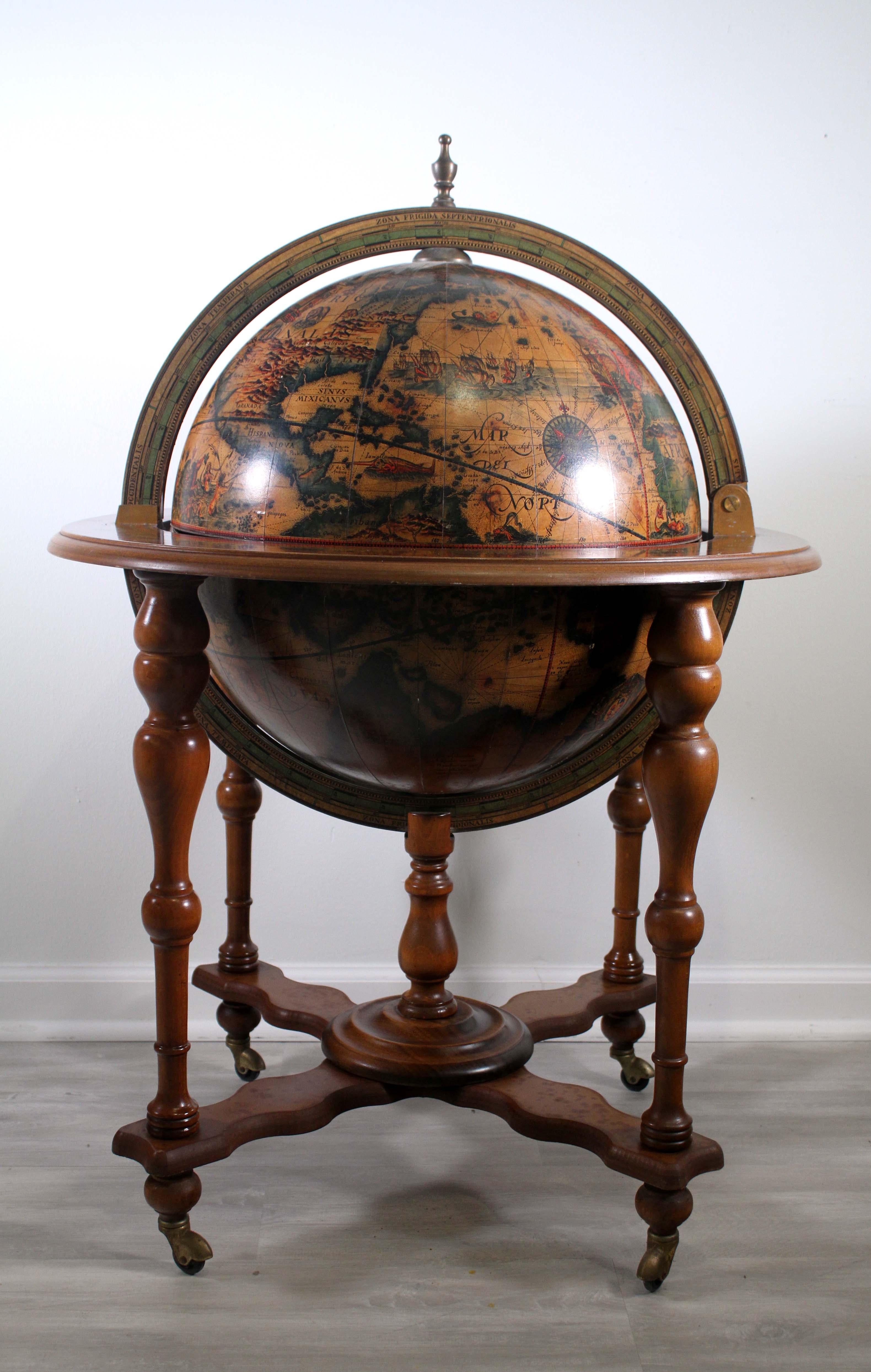 This vintage 1960s Italian dry bar is perfect for adding a touch of classic European style to your home. The world globe design is made of wood, giving it an authentic and timeless look. The wood is finished with a rich walnut stain, bringing out