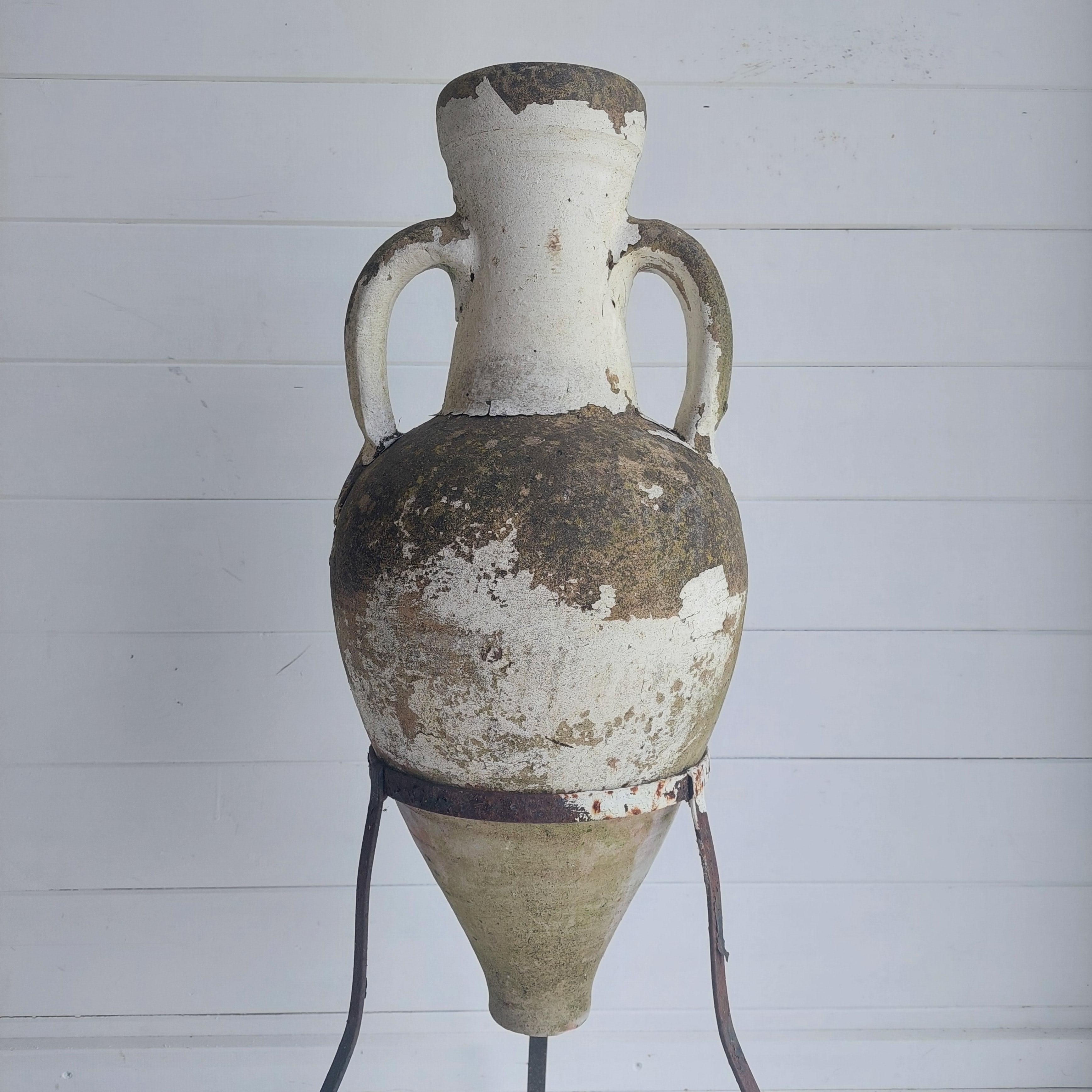Unique shaped terracotta Greek amphora.
Fantastic 'elongated' form.
On iron tripod stand.
Beautiful decorative amphora that replicates the Ancient Greek amphora that was used as a storage and transportation jar.
Amphora with cylindrical neck