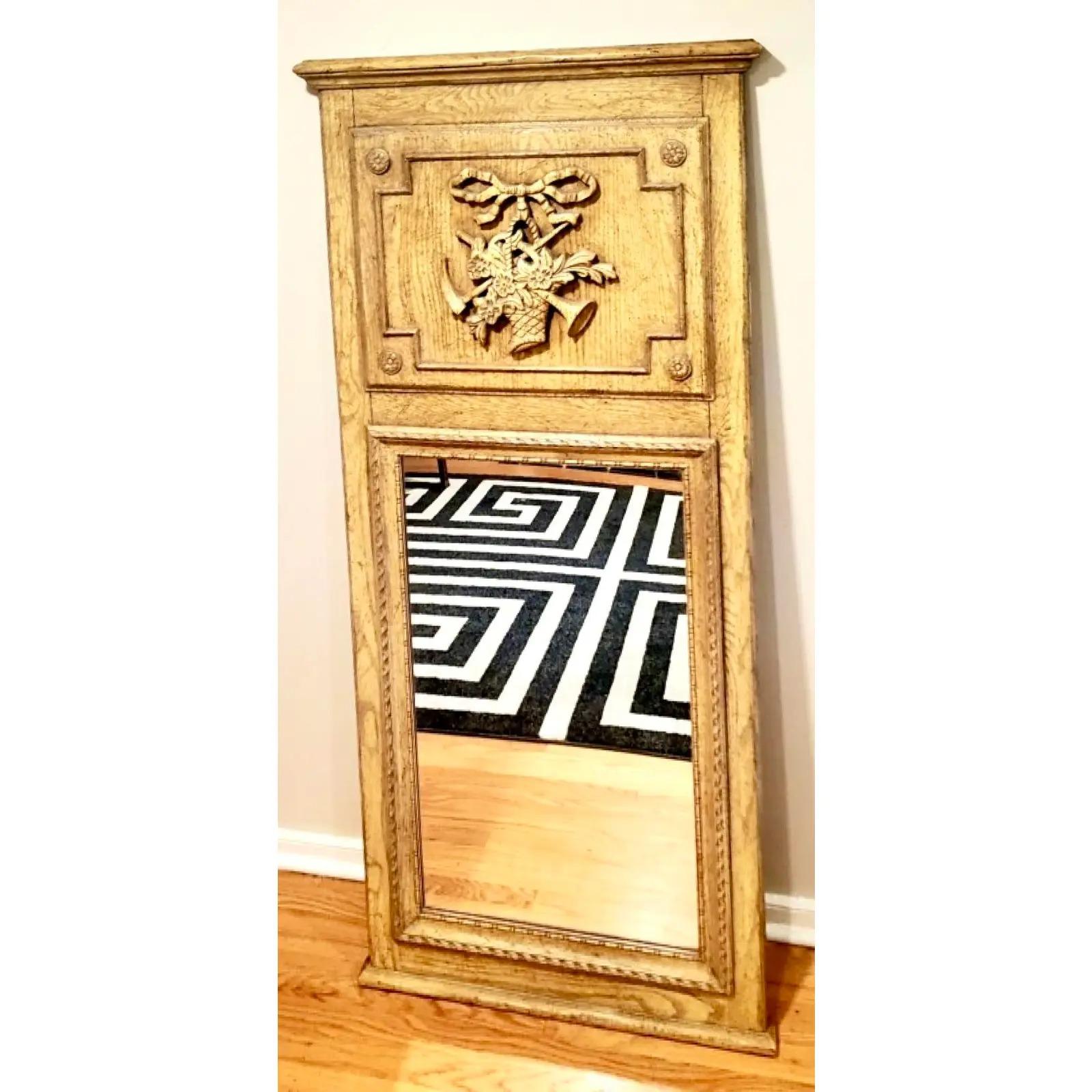 Fantastic vintage Antiqued Trumeau mirror. Made by the iconic Baker Furniture company. Beautiful hand carved detail. Acquired from a Palm Beach estate.