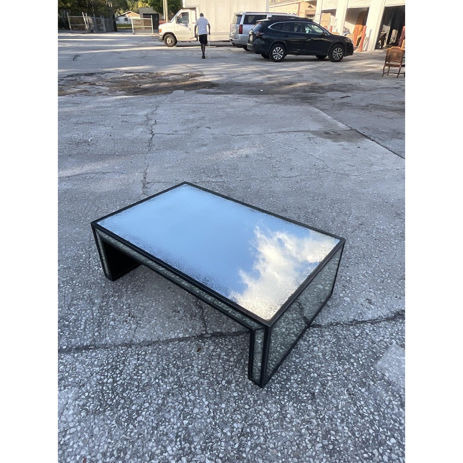 Gorgeous vintage Regency coffee table. Chic black frame with inset antiqued mirrored panels. Would look great in so many different décor styles.
