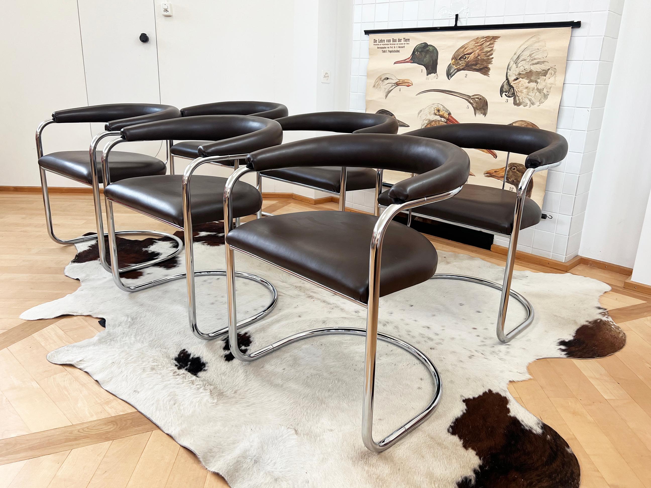 Stunning Anton Lorenz for Thonet Cantilevered Armchairs, set of 6
They feature very dark brown upholstered backrests and seats with polished chrome tubular frames. All are in superb condition throughout.

The chairs were acquired by a collector in