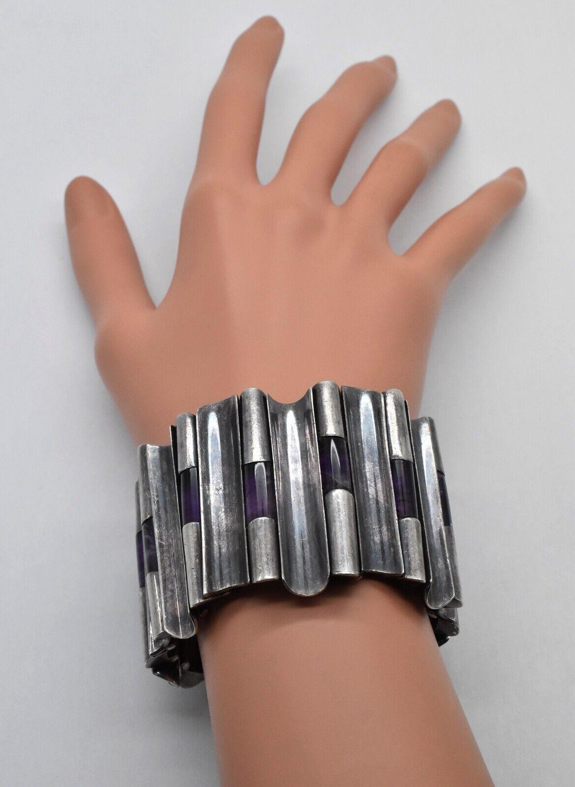 This striking vintage bracelet by renowned Mexican silversmith Antonio Pineda is crafted in high-purity .970 silver and showcases his iconic sculptural design. Composed of a series of curved vertical silver panels, the bracelet is interspersed with