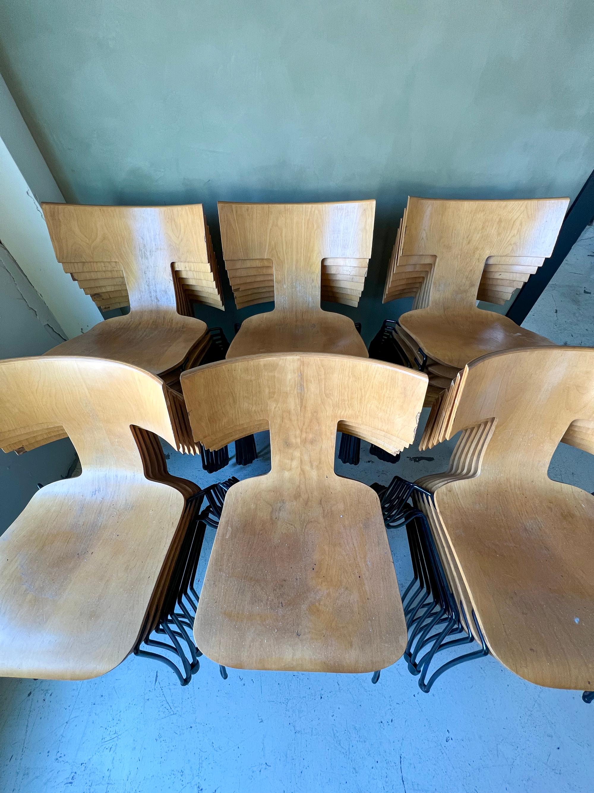 Designed by John Hutton for the American Academy in Rome, the Anziano chair is made of a molded plywood seat and iron base. The chairs are are very comfortable and have a good amount of flex. The chairs all have some chipping in the veneer on the