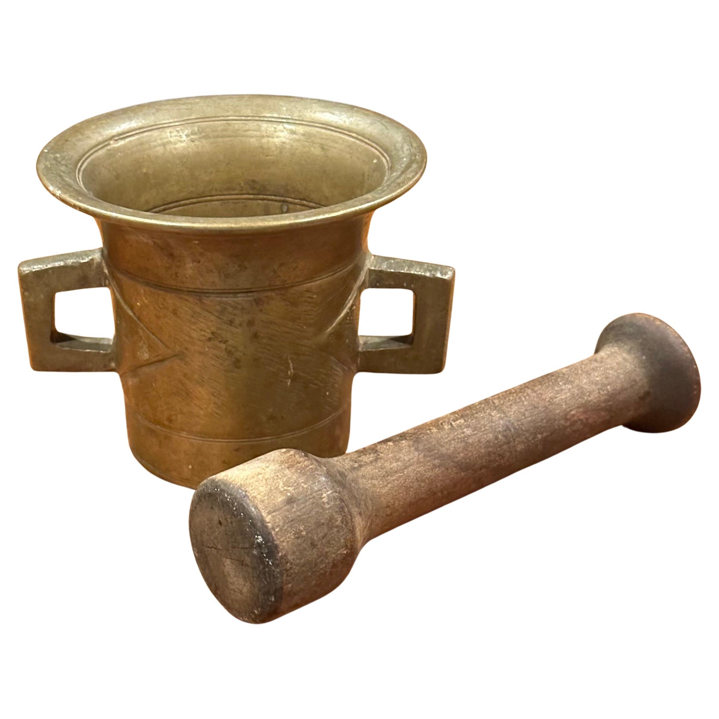 A nice vintage apothecary bronze mortar and wood pestle, circa 1950s.  The piece is in good vintage condition with a nice patina and measures 5