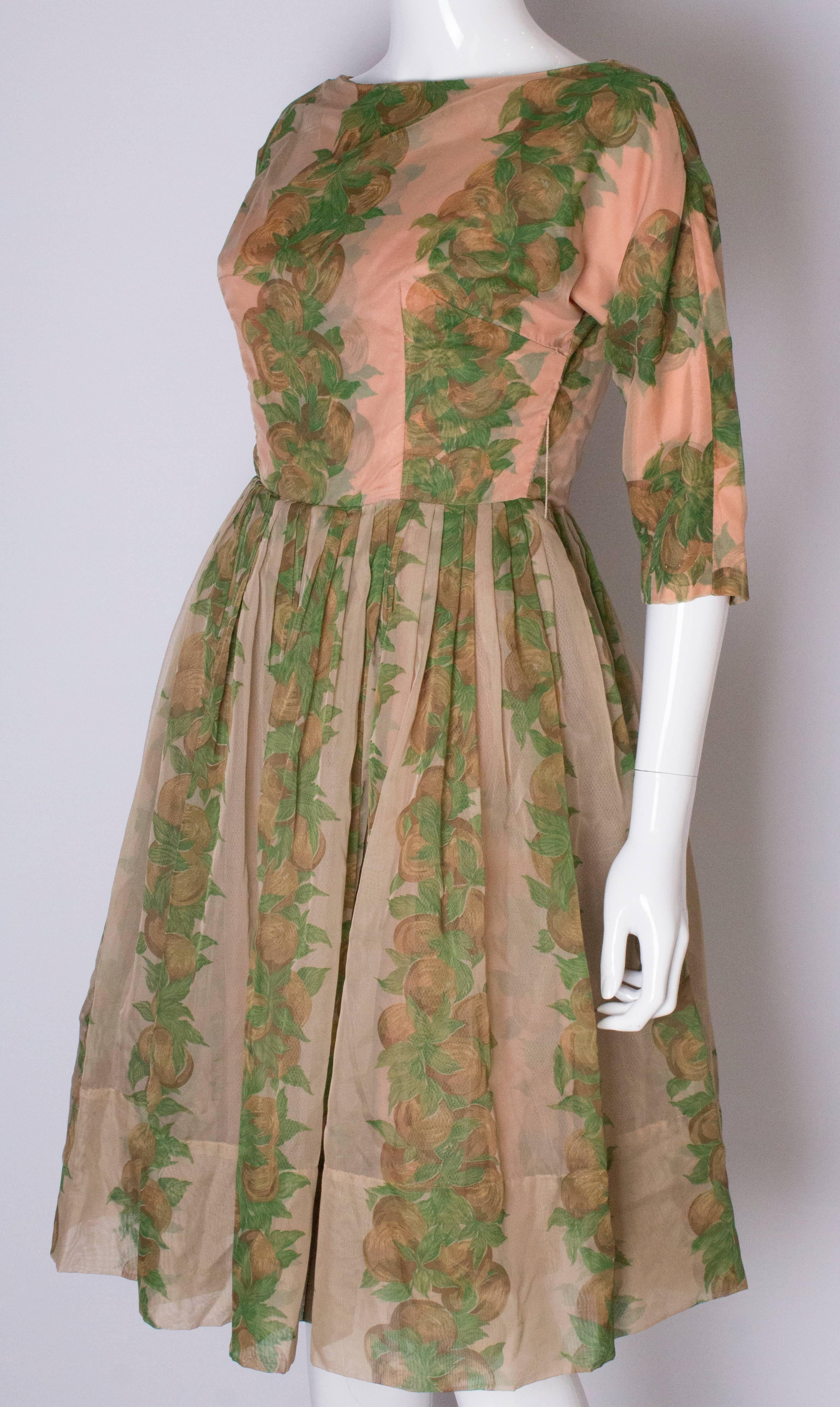 Women's A Vintage 1950s Apricot, Green and Brown print swing cinch party dress
