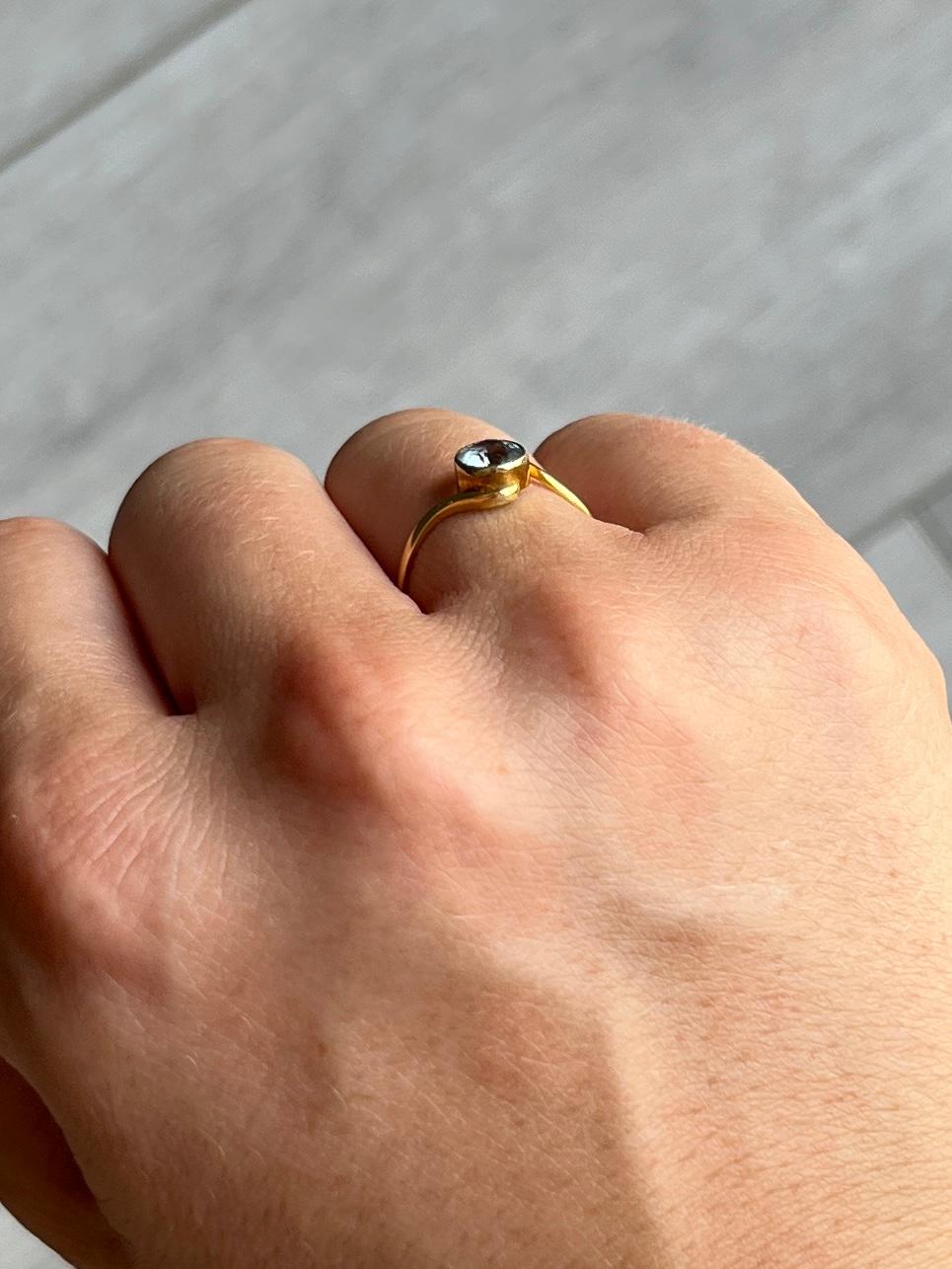 This stunning aqua is pale in colour. The setting is decorative and the ring is modelled in 18carat gold. The stone measures approx 50pts. 

Ring Size: J 1/2 or 5 
Height Off Finger: 4mm
Stone Diameter: 5.5mm 

Weight: 1g