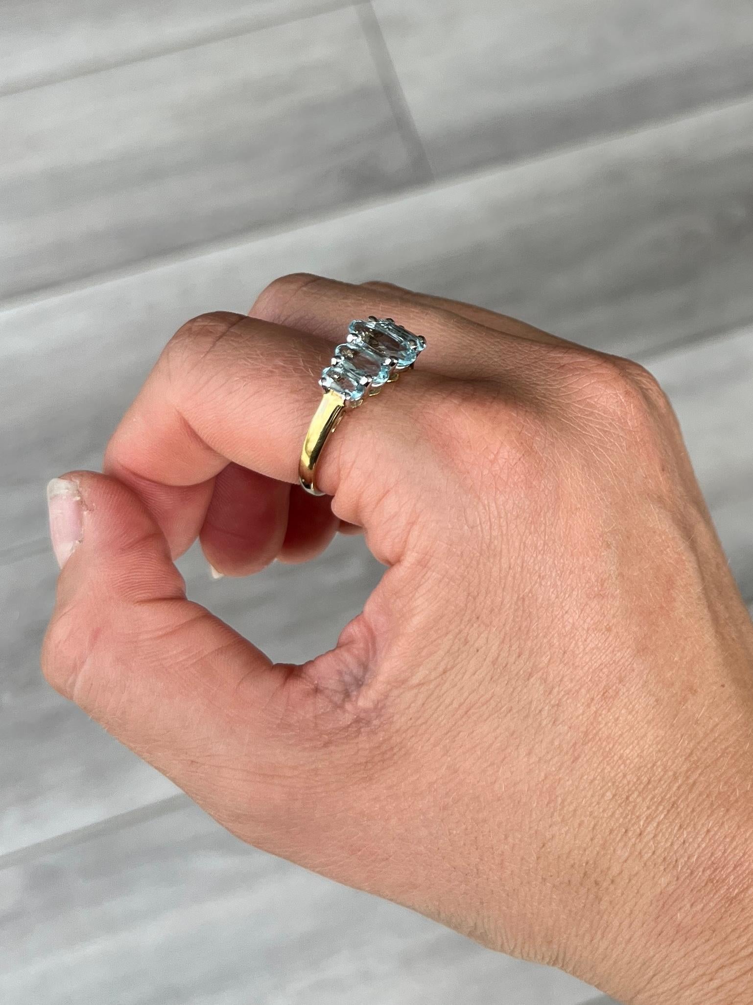 This ring holds five oval pale blue aqua stones. The total carat weight of the stones is 2.9ct. Modelled in 9carat gold.

Ring Size: T or 9 1/2
Width: 10mm
Height Off Finger: 6mm

Weight: 2.9g