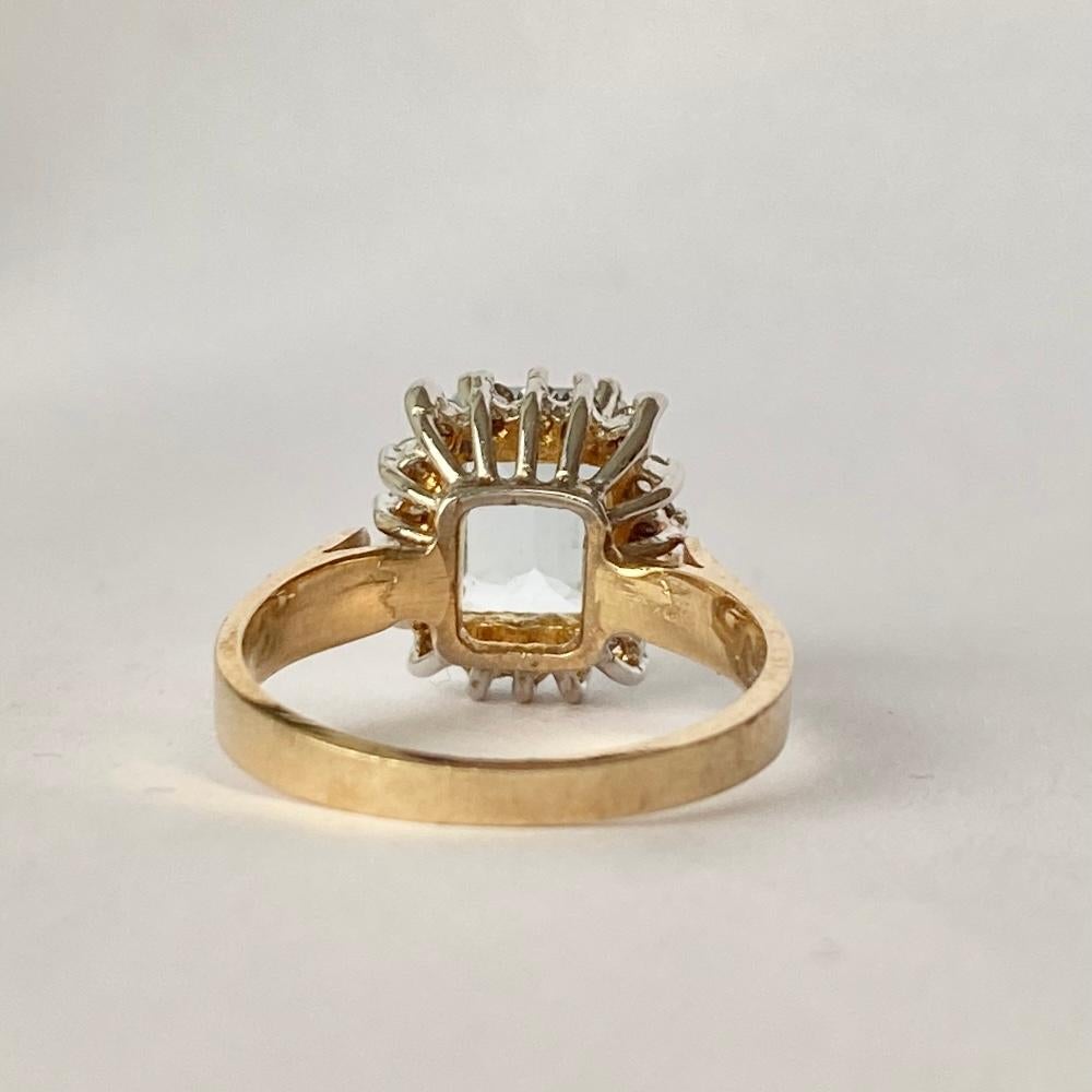 Sitting proud at the centre of this wonderful cluster ring is a sparkling emerald cut aqua stone. Around the 1.5ct aqua stone sit a halo of smaller diamonds each measuring approximately 2pts each. All sit on an open work setting with simple