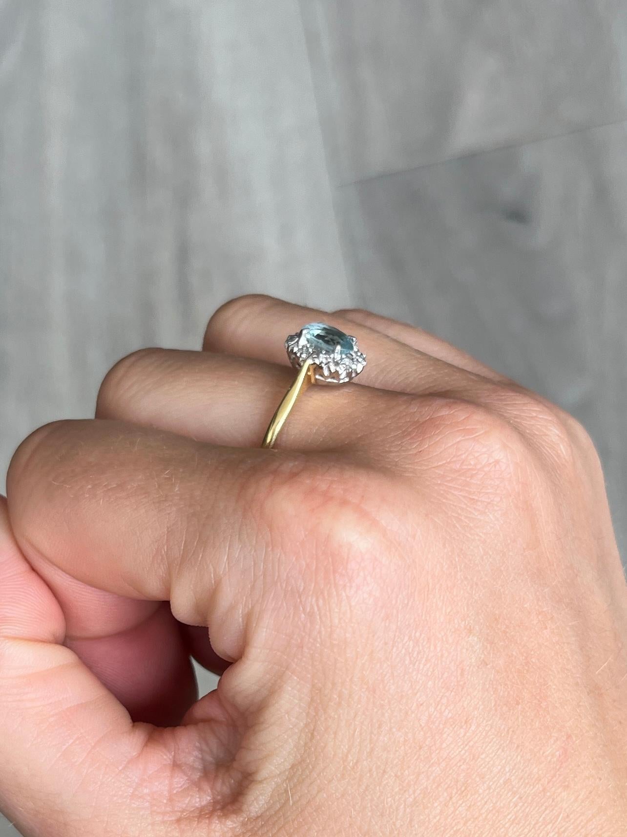 Sitting proud at the centre of this wonderful cluster ring is a sparkling aquamarine stone. Around the 80pt aquamarine stone sit a halo of smaller diamonds each measuring approximately 2pts each. All sit on an open work setting with simple