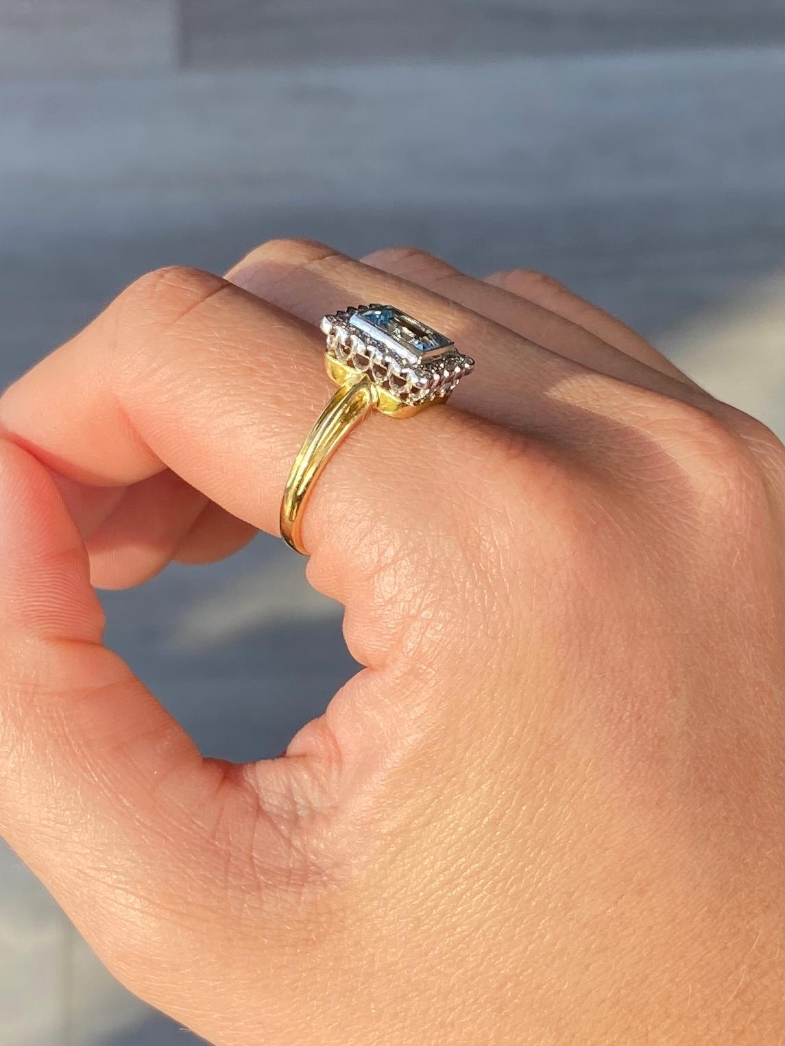 Sitting proud at the centre of this wonderful cluster ring is a sparkling emerald cut aqua stone. Around the 1.5ct aqua stone sit a halo of smaller diamonds measuring a total of 35pts. 

Ring Size: P or 7 3/4 
Centre Stone Dimension: