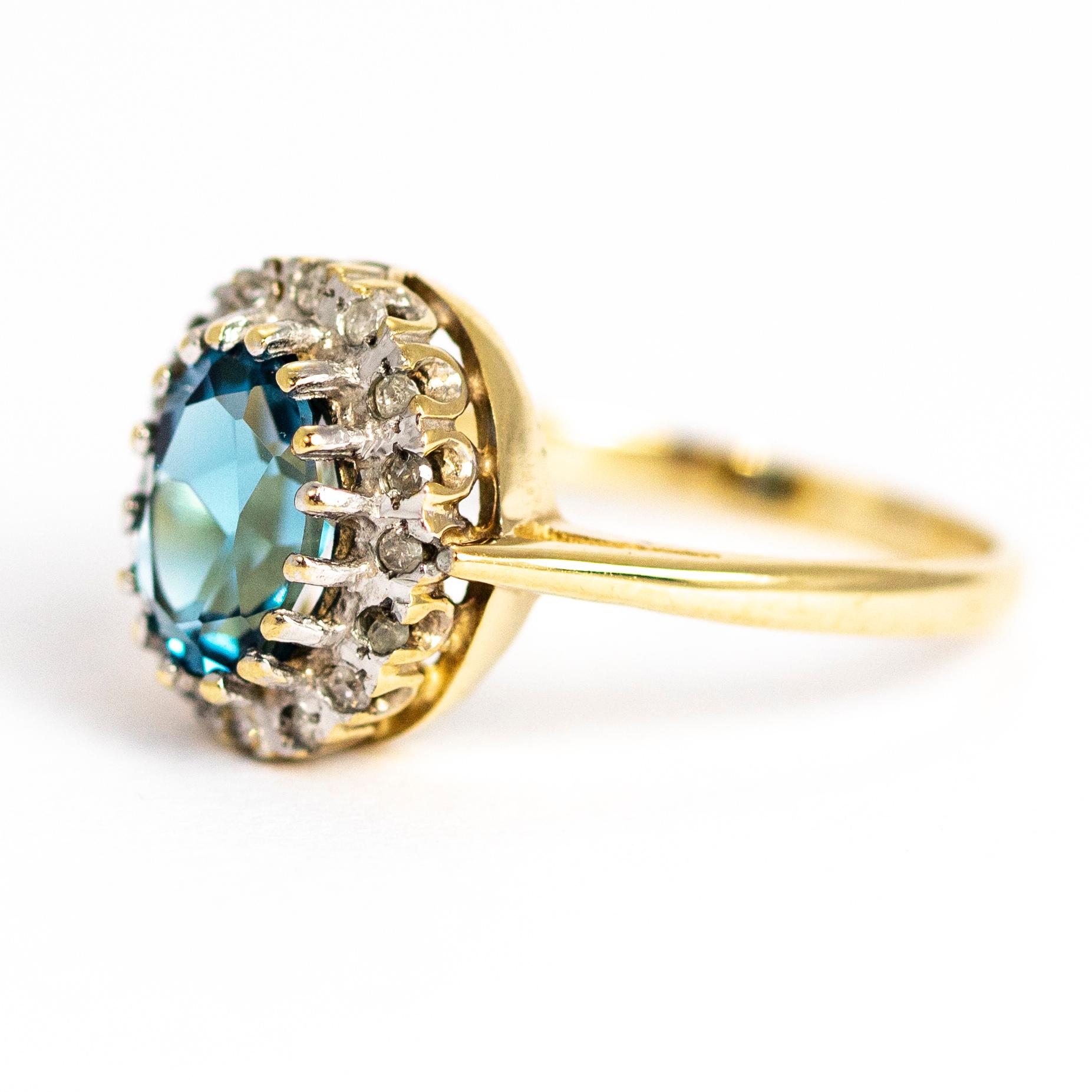 Perched in the centre of this cluster ring is a striking pale blue Aqua stone. Surrounding it is a hoop of smaller sparkling diamonds. The aqua measures approximately 1 carat. Modelled in 9ct gold. Made in Birmingham, England.

Ring size: M or 6 1/4