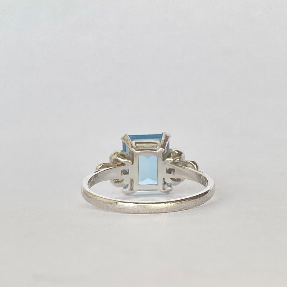 The gorgeous pale blue emerald cut aqua in this cocktail ring is stunning and measures approx 2carat. Either side of the stone are diamond encrusted shoulders holding three diamonds. The diamond total of the ring Is 50pts. 

Ring Size: N 1/2 or 7