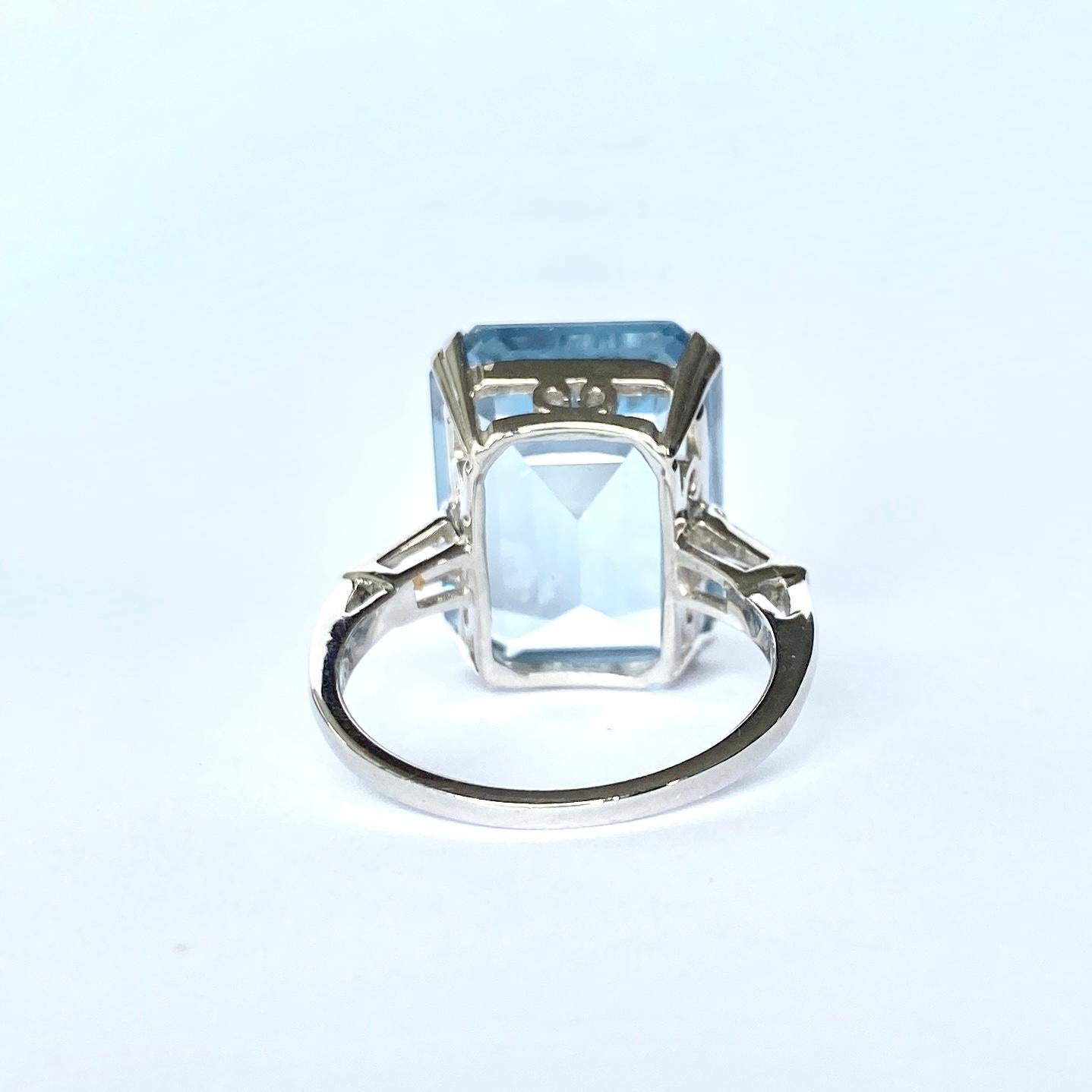 The gorgeous pale blue emerald cut aqua in this cocktail ring is stunning. Either side of the aqua stone are tapered baguette diamonds. The diamond total of the ring Is 30pts and modelled in platinum. 

Ring Size: S 1/2 or 9 1/4 
Stone Dimensions: