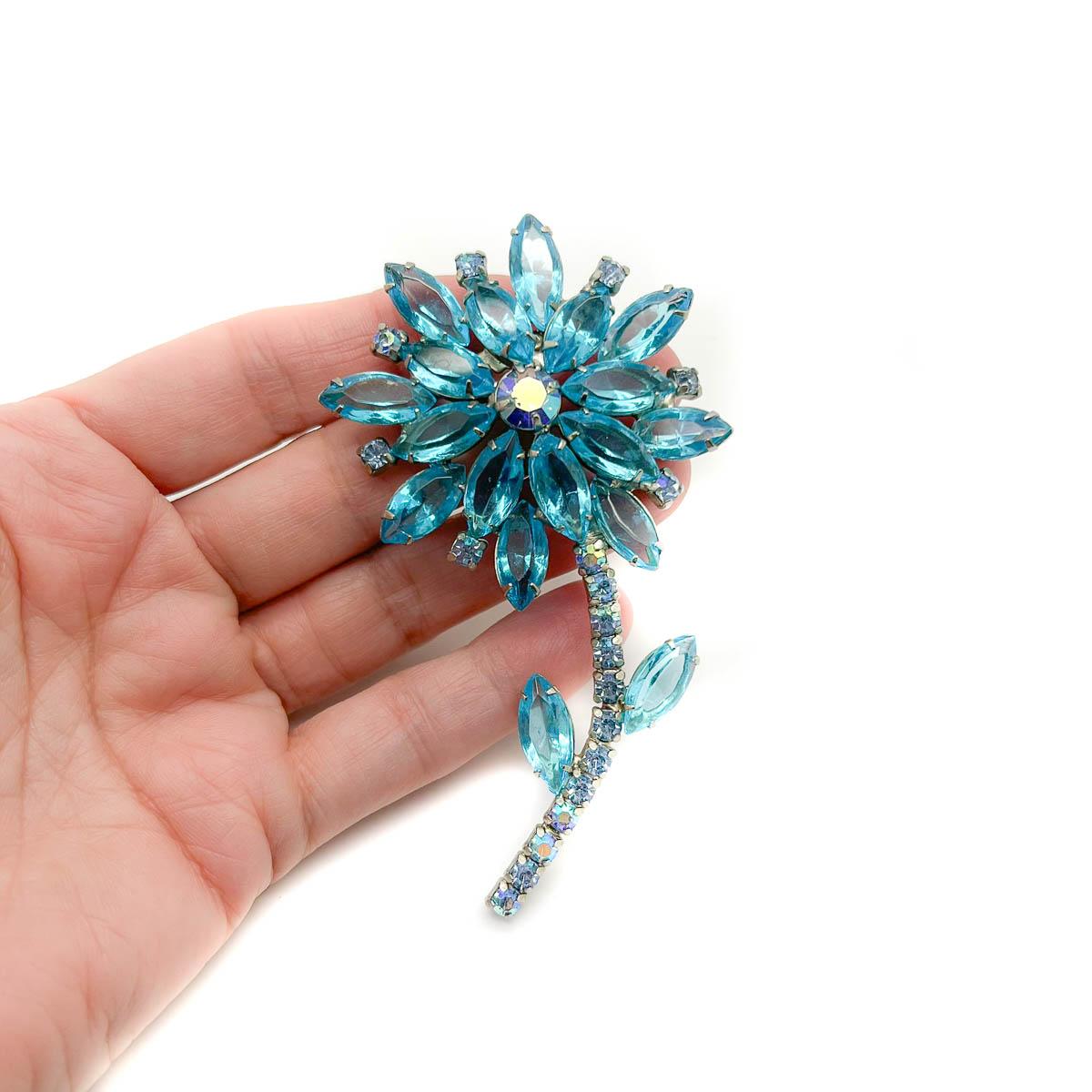A Vintage Aqua Crystal Flower. A timeless and beautiful treasure for your lapel.
An unsigned beauty. A rare treasure. Just because a jewel doesn’t carry a designer name, doesn’t mean it isn't coveted. The unsigned beauties in our collection are