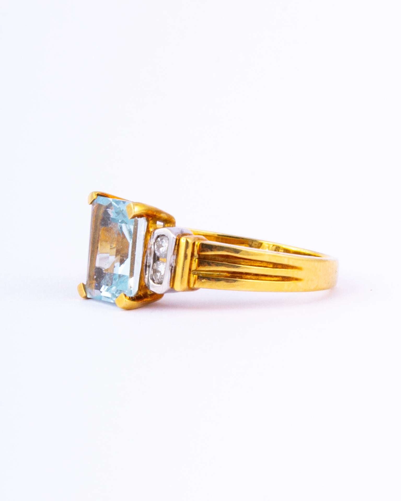 Set high in simple claws and gallery modelled in 18ct gold is the most stunning aqua stone. The aqua is a pale blue and is emerald cut which reflects the light beautifully. Either side of this stone sits a pair of diamonds measuring a total of 5pts