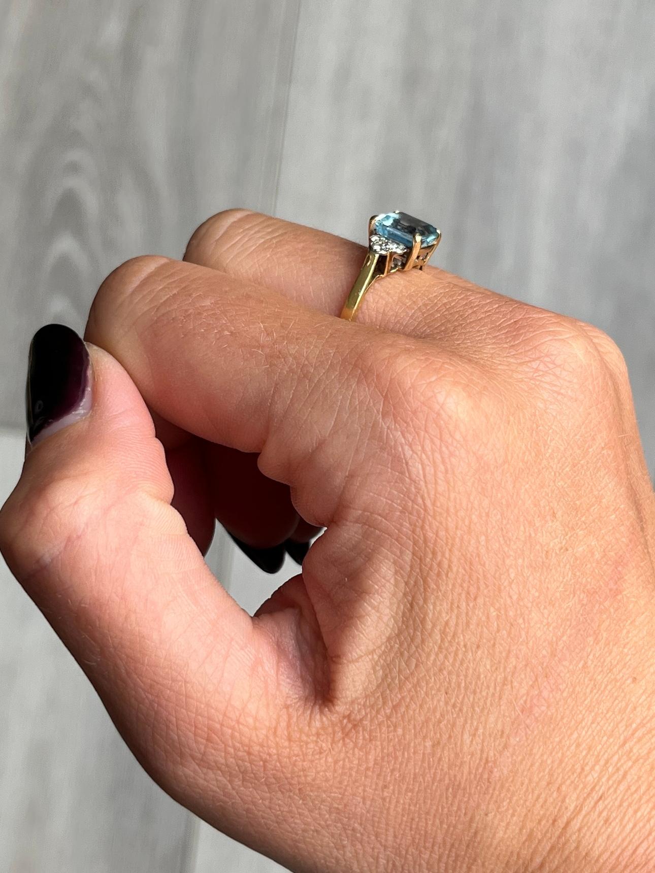 Set in a simple setting modelled in 18carat gold this aquamarine stone measures 1.1ct. Either side of the stone are diamonds which total 30pts. The ring is modelled in 18ct gold and diamonds set in platinum.

Ring Size: M 1/2 or 6 1/2
Stone
