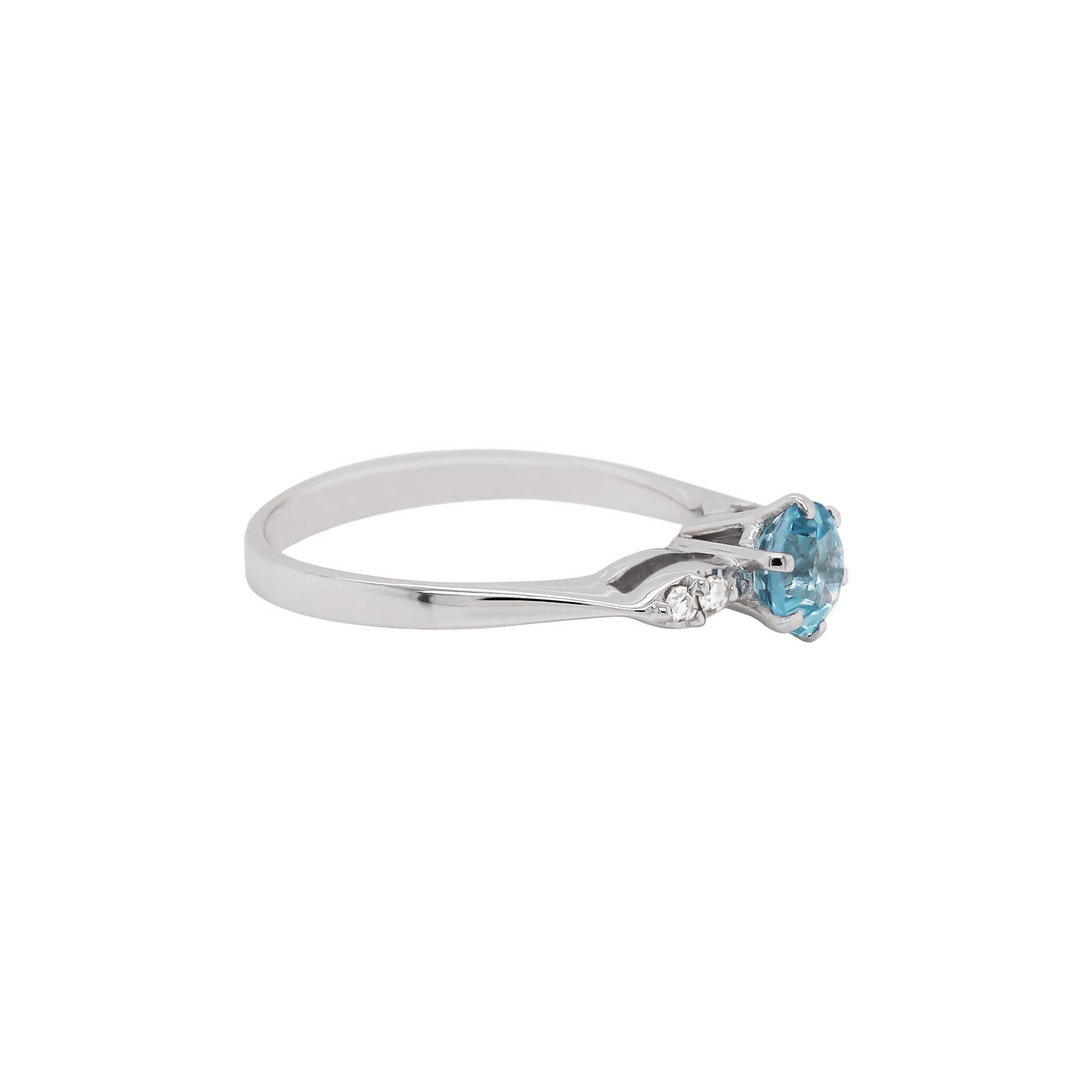 Beautiful 1970’s ring featuring a round aquamarine weighing approximately 0.50ct mounted in a six claw open back setting. The aquamarine is beautifully accompanied by a marquise shape mount on either side set with two eight cut diamonds weighing a