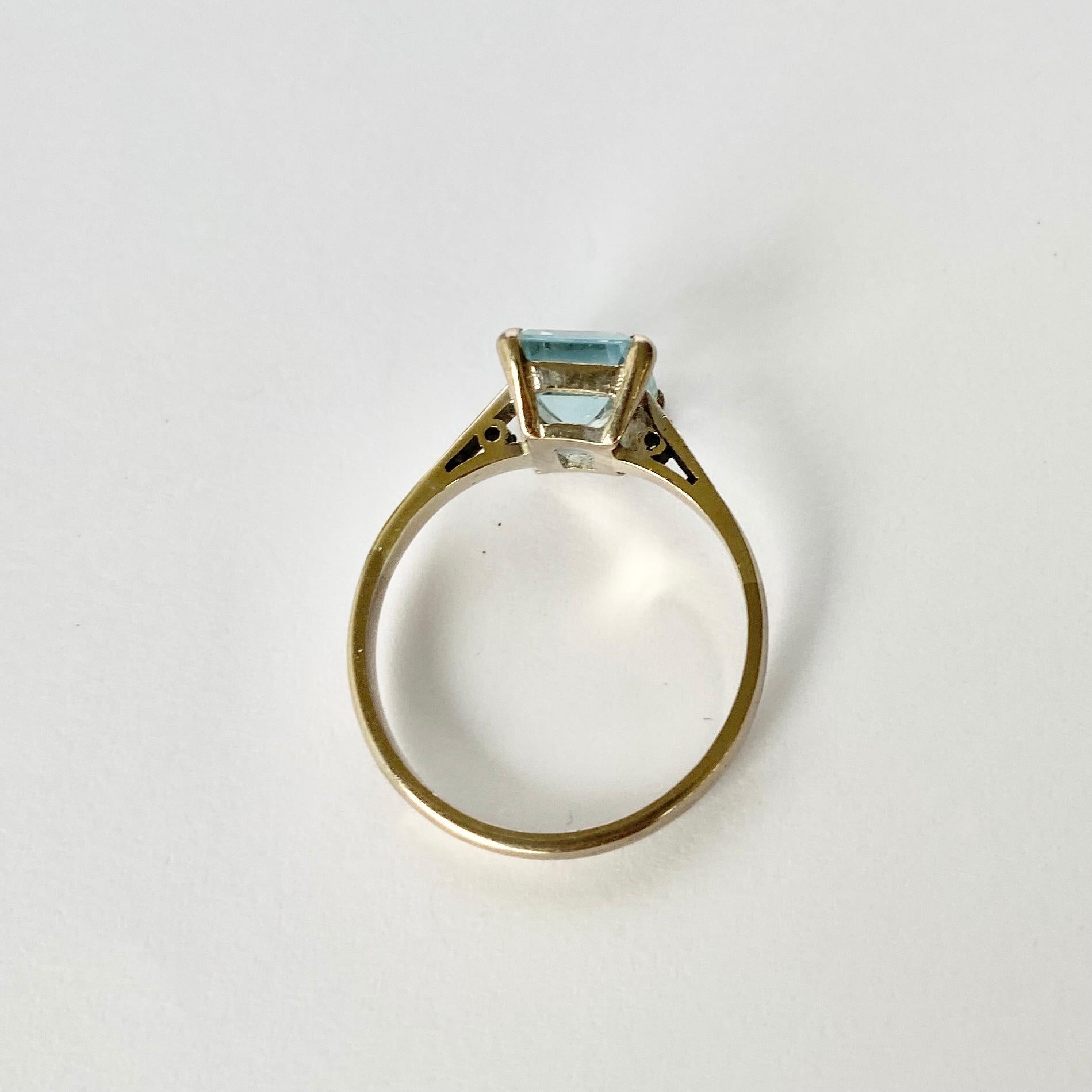 Set high in simple claws and gallery modelled in 18ct white gold is the most stunning aqua stone. The aqua is a pale blue and is emerald cut which reflects the light beautifully. Either side of this stone sits a pair of diamond points. 

Ring Size: