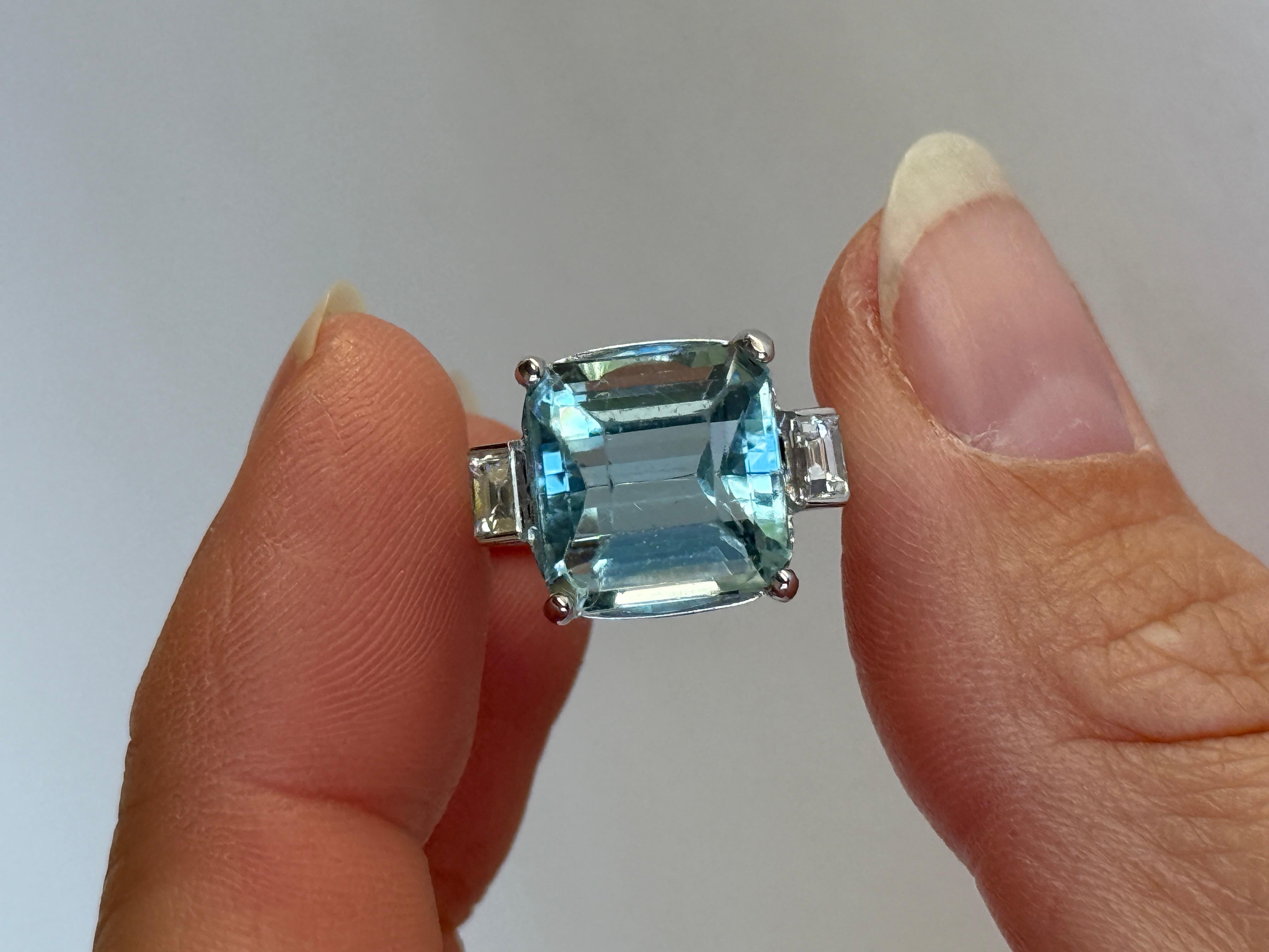 Der wunderschöne Aquamarin in diesem Ring leuchtet hell und ist an beiden Seiten mit Baguette-Diamanten besetzt. Der Aqua misst ca. 5,18 Karat und die Diamanten insgesamt 20pts. Der Ring ist aus 18 Karat Weißgold gefertigt. 

Ring Größe: L 1/2 oder