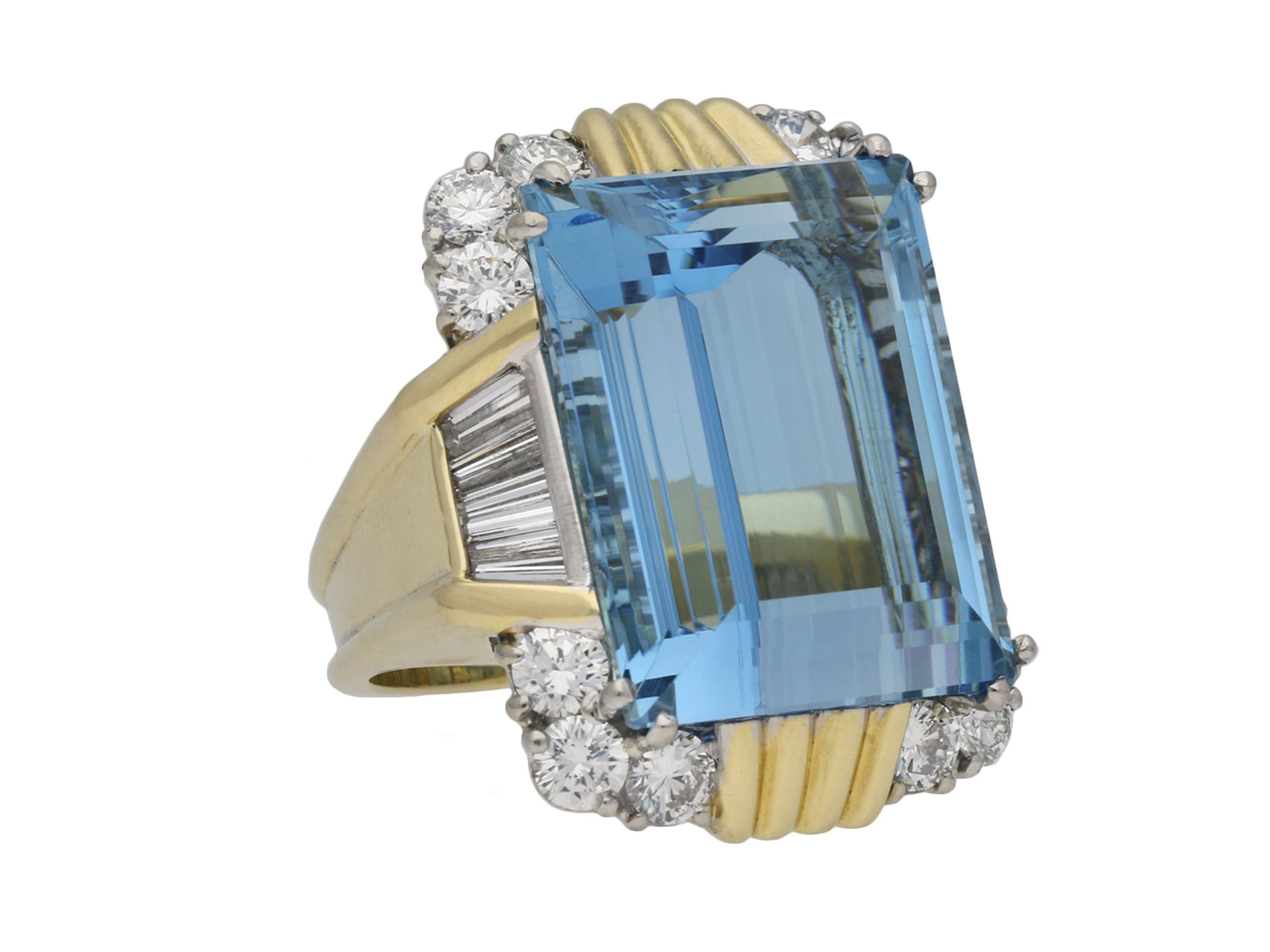 Vintage aquamarine and diamond cocktail ring. Set with a rectangular step-cut natural aquamarine in an open back split corner claw setting with an approximate weight of 29.29 carats, flanked by eight tapered baguette cut diamonds in open back
