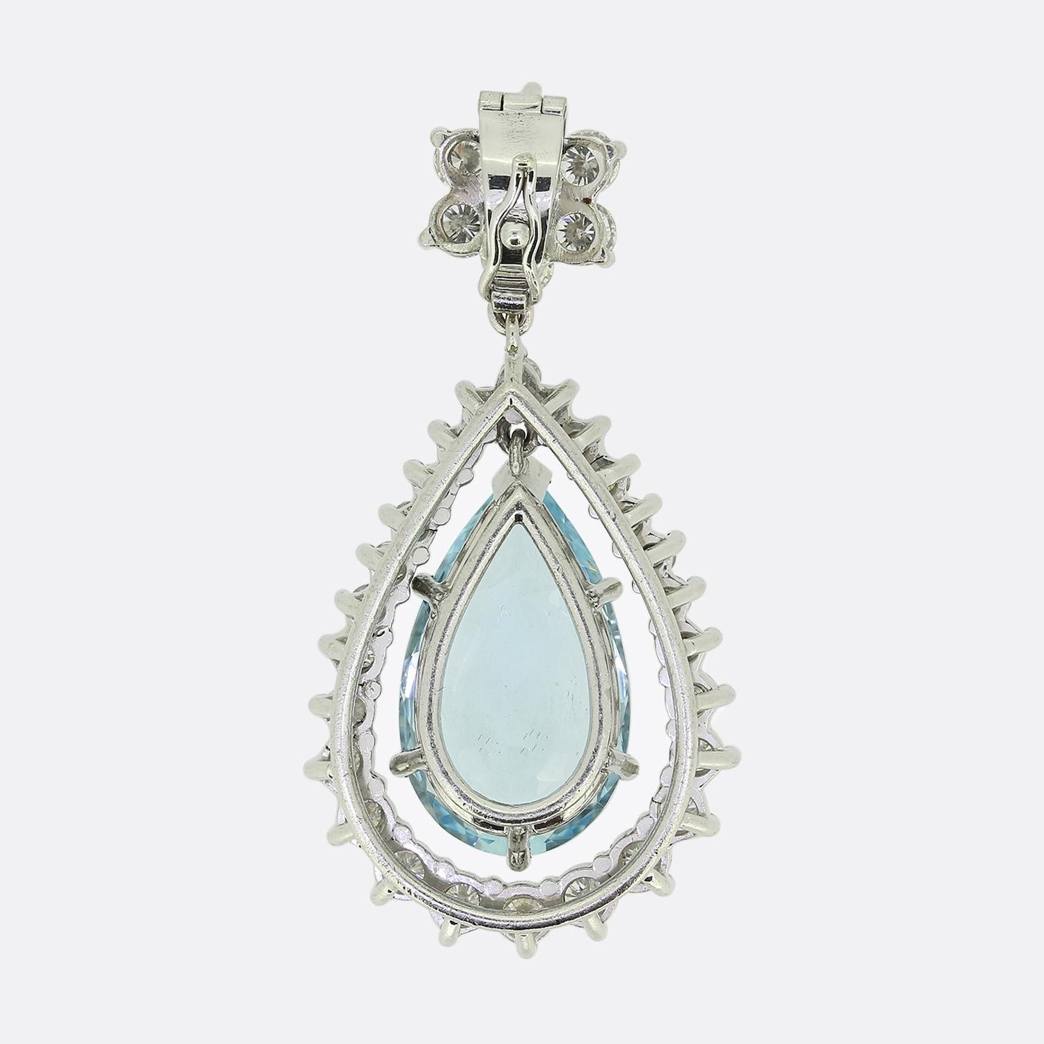 Here we have a fabulous vintage drop pendant. This piece has been crafted from 18ct white gold and showcases a large pear shaped aquamarine at the centre which swings freely amidst a frame of round brilliant cut diamonds. Collectively this ensemble