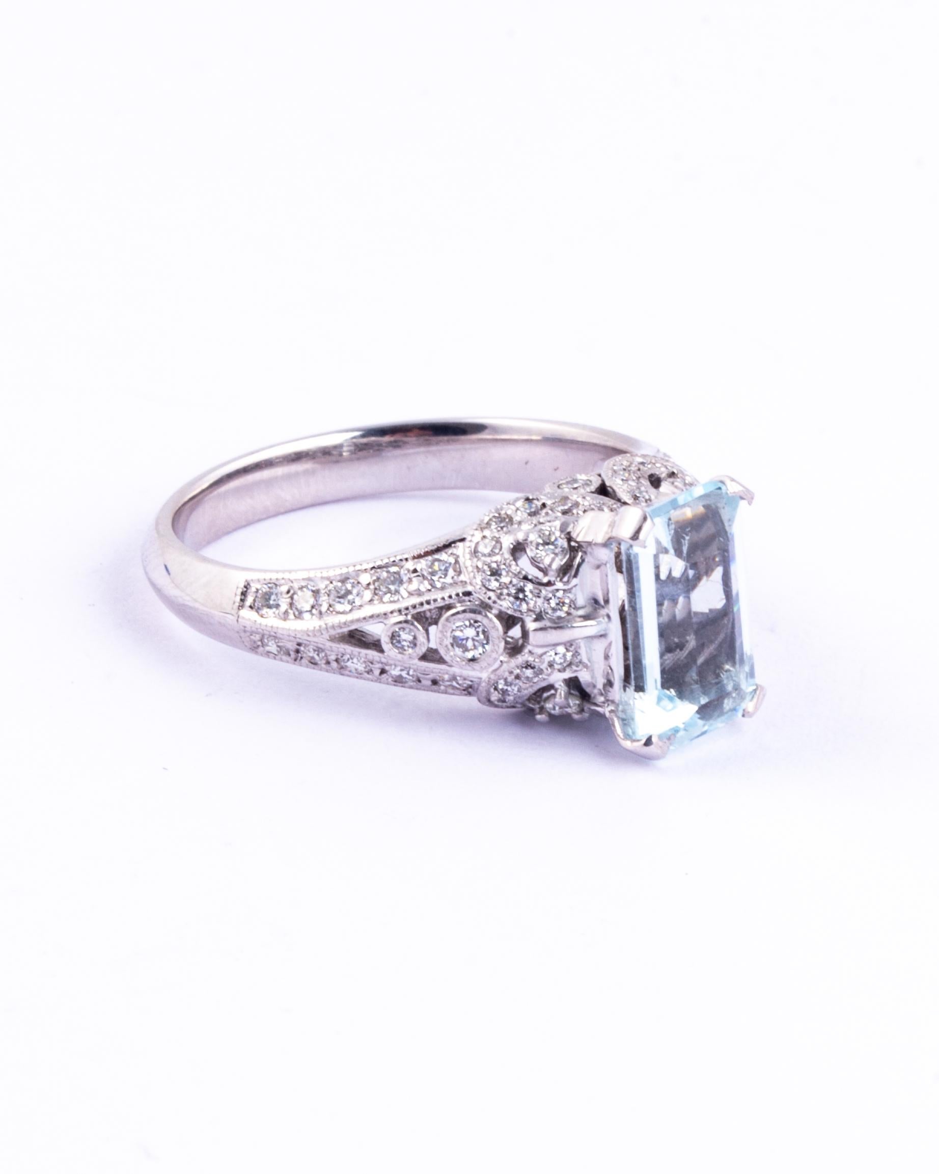Set high in simple claws modelled in platinum is the most stunning aqua stone. The gallery and shoulders are diamond encrusted totalling approx 90pts. The aqua is a pale blue and is emerald cut which reflects the light beautifully.

Ring Size: Q or