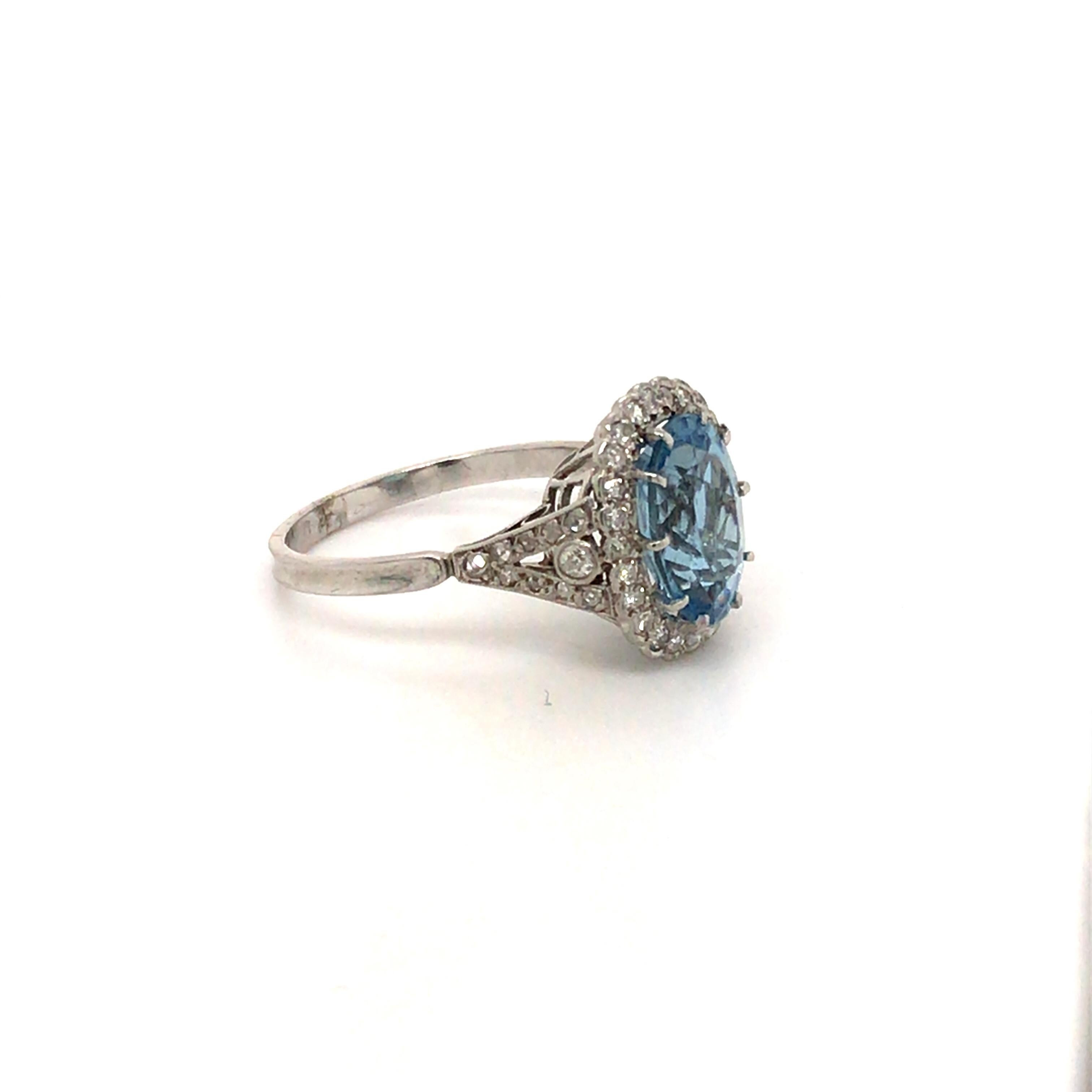 This fine oval Aquamarine is mounted in a hand made platinum setting with diamond scallop surround and old cut diamond diamond shoulders. 

Aquamarine - 3.20ct
Old Cut Diamonds - 46 total approx 0.70ct
