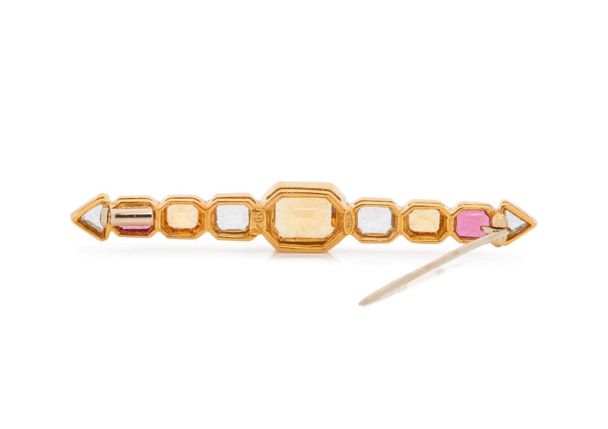 This is a stunning multi stone double arrow design brooch set with natural citrines, aquamarines and pink tourmalines.  The brooch is hallmarked 750 and has a makers mark R. There are 4 aquamarines, 3 citrines and 2 pink tourmalines.  The stones all