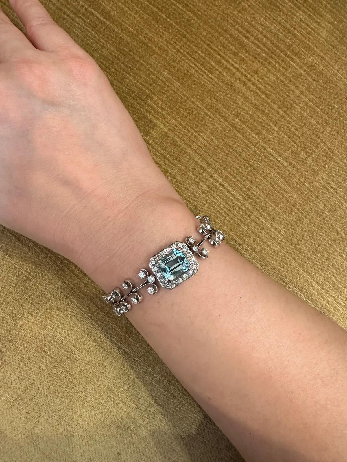 Vintage Aquamarine & Diamond Bracelet in Platinum 7.5 inches 

Vintage Aquamarine & Diamond Bracelet features rounded T shaped links with 2 Round Brilliant Diamonds each and a centerpiece light blue Emerald cut Aquamarine surrounded by Round