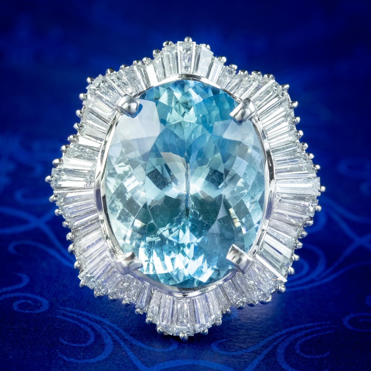 An outstanding aquamarine and diamond cocktail ring from the late 20th Century boasting a magnificent oval cut aquamarine in the centre with glistening facets that mimic light flickering on the surface of an icy blue pool. It’s accompanied by a
