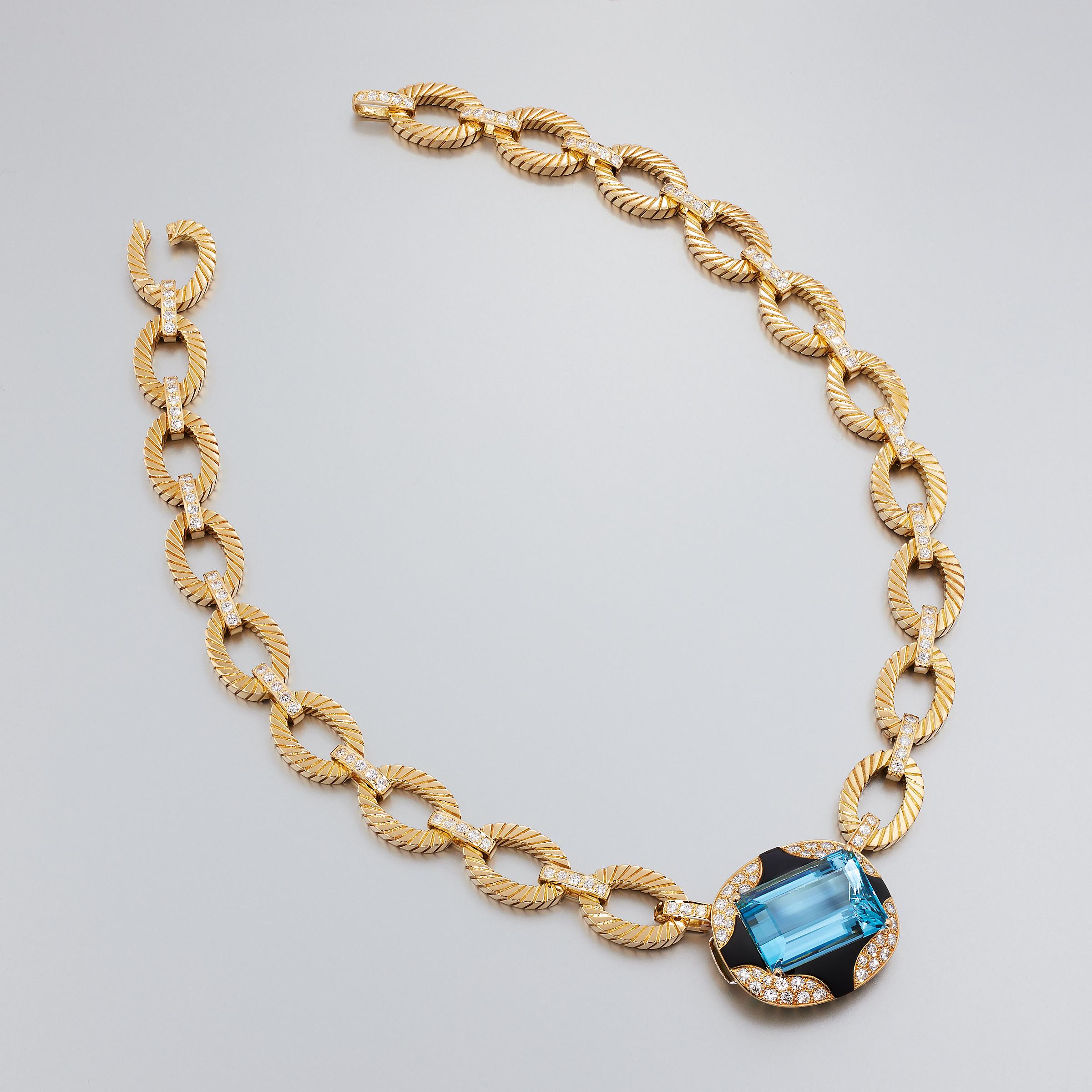 Exceptional one-of-a-kind aquamarine diamond and black onyx suite attributed to Mauboussin Paris and set in 18 karat yellow gold. This impressive suite consists of a necklace, bracelet, and earrings and is a vintage creation dating to 1980s. It is