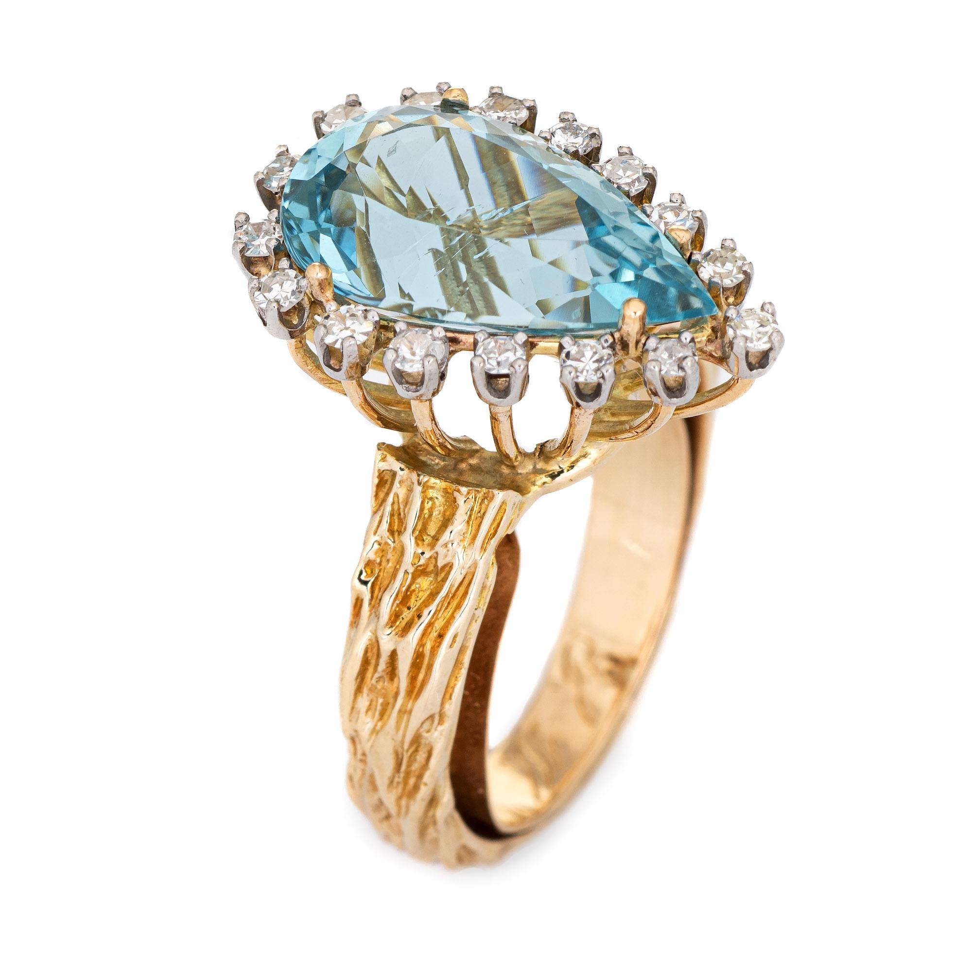 Stylish vintage aquamarine & diamond cocktail ring (circa 1960s to 1970s) crafted in 14 karat yellow gold. 

Pear cut aquamarine measures 15mm x 9mm (estimated at 5 carats), accented with 16 single cut diamonds that total an estimated 0.16 carats