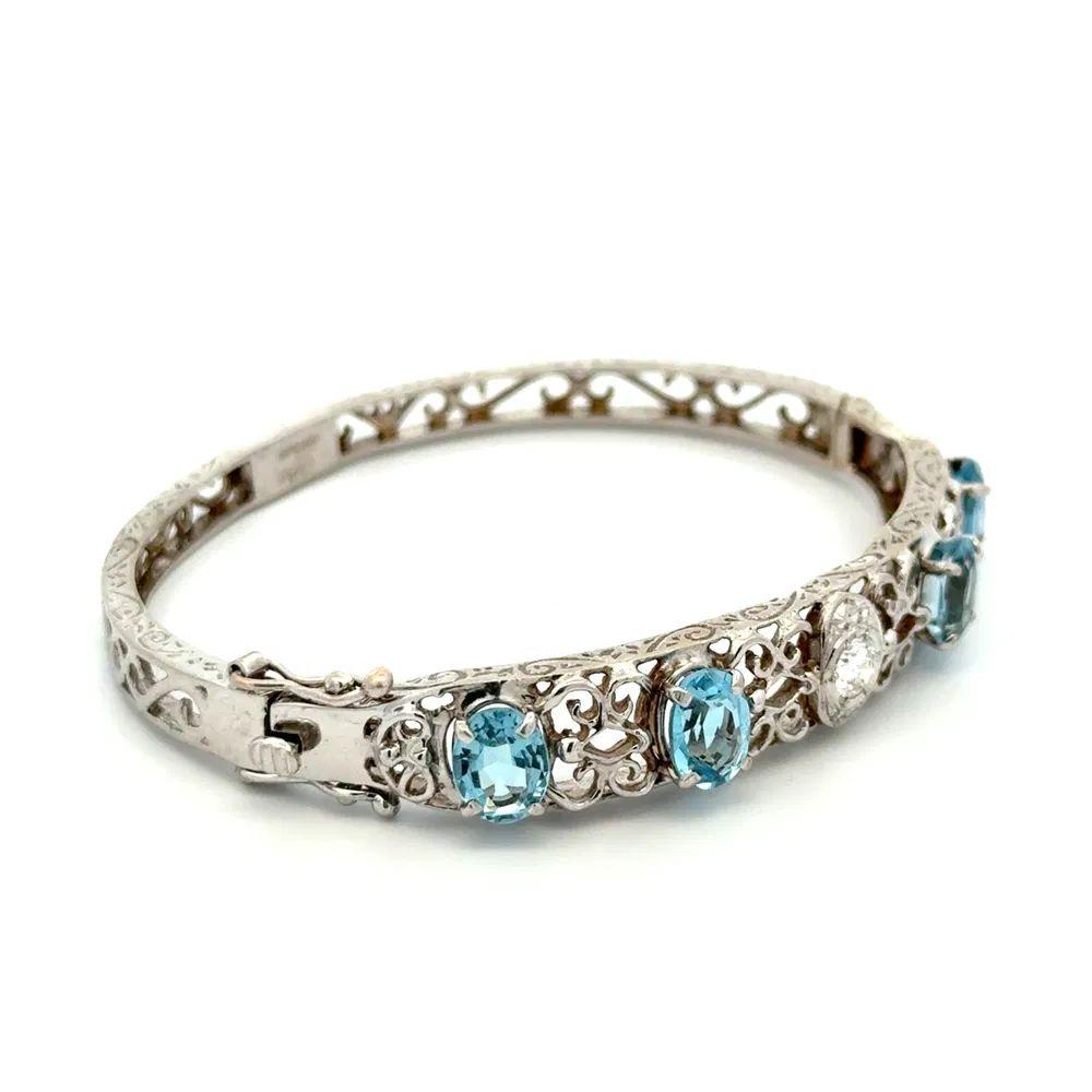 Simply Beautiful! Vintage Aquamarine and Diamond Gold Statement Bangle Bracelet. Securely Hand set with 4 Aquamarine Gemstones, weighing approx. 6tcw and enhanced with .25tcw Diamonds. Exquisitely Hand crafted in 14K Engraved White Gold. Chic and